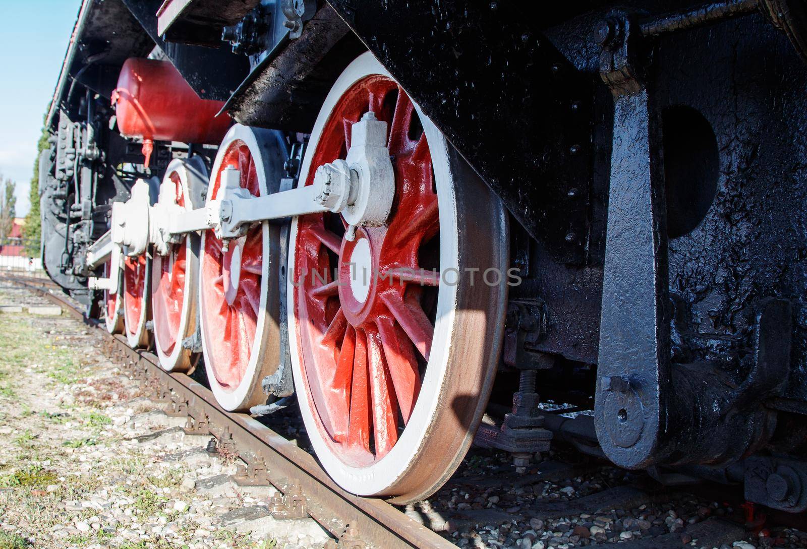 old vintage locomotive wheels closeup outdoor on sunny day