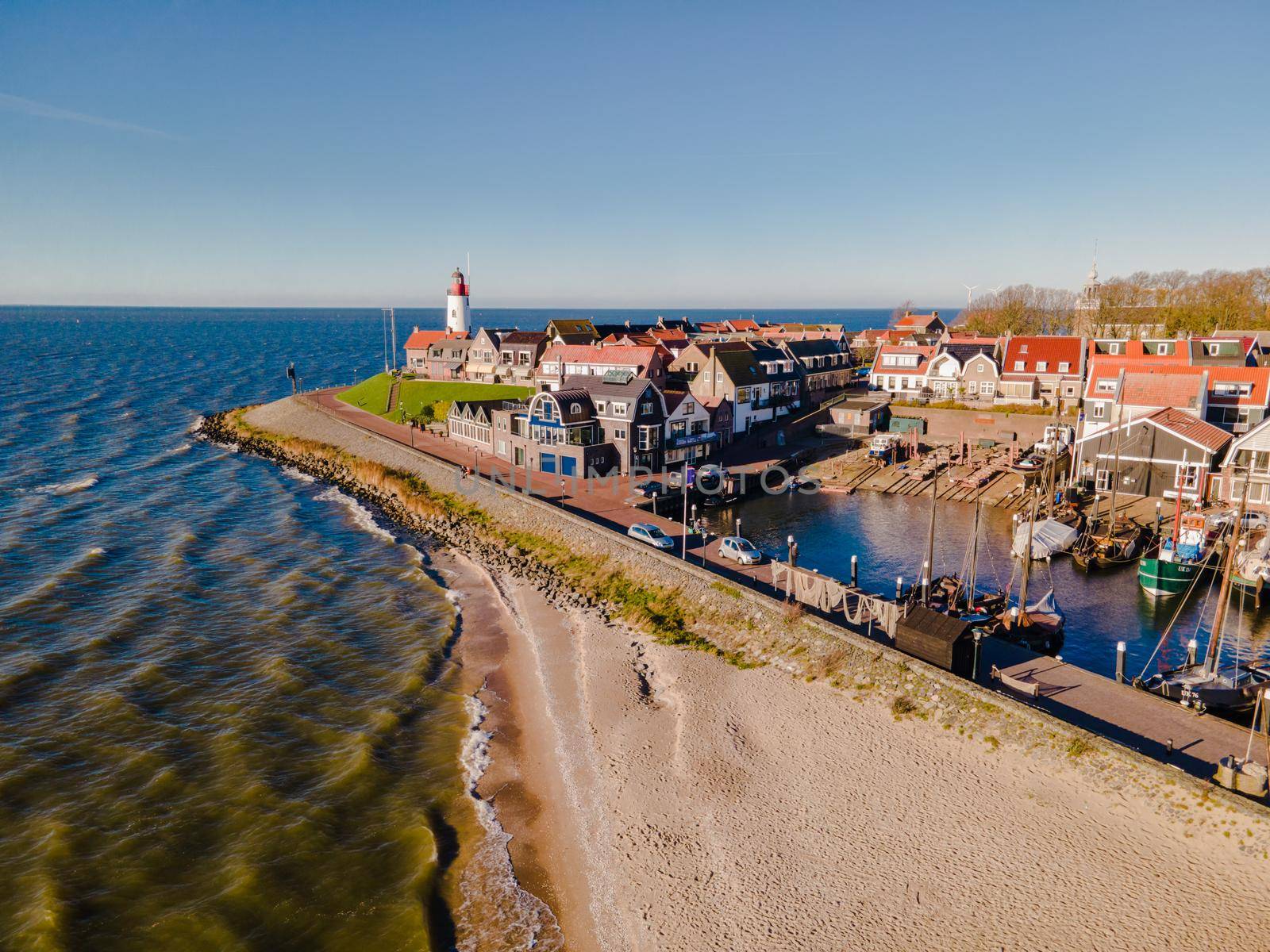 Urk lighthouse with old harbor during sunset, Urk is a small village by the lake Ijsselmeer in the Netherlands Flevoland area by fokkebok