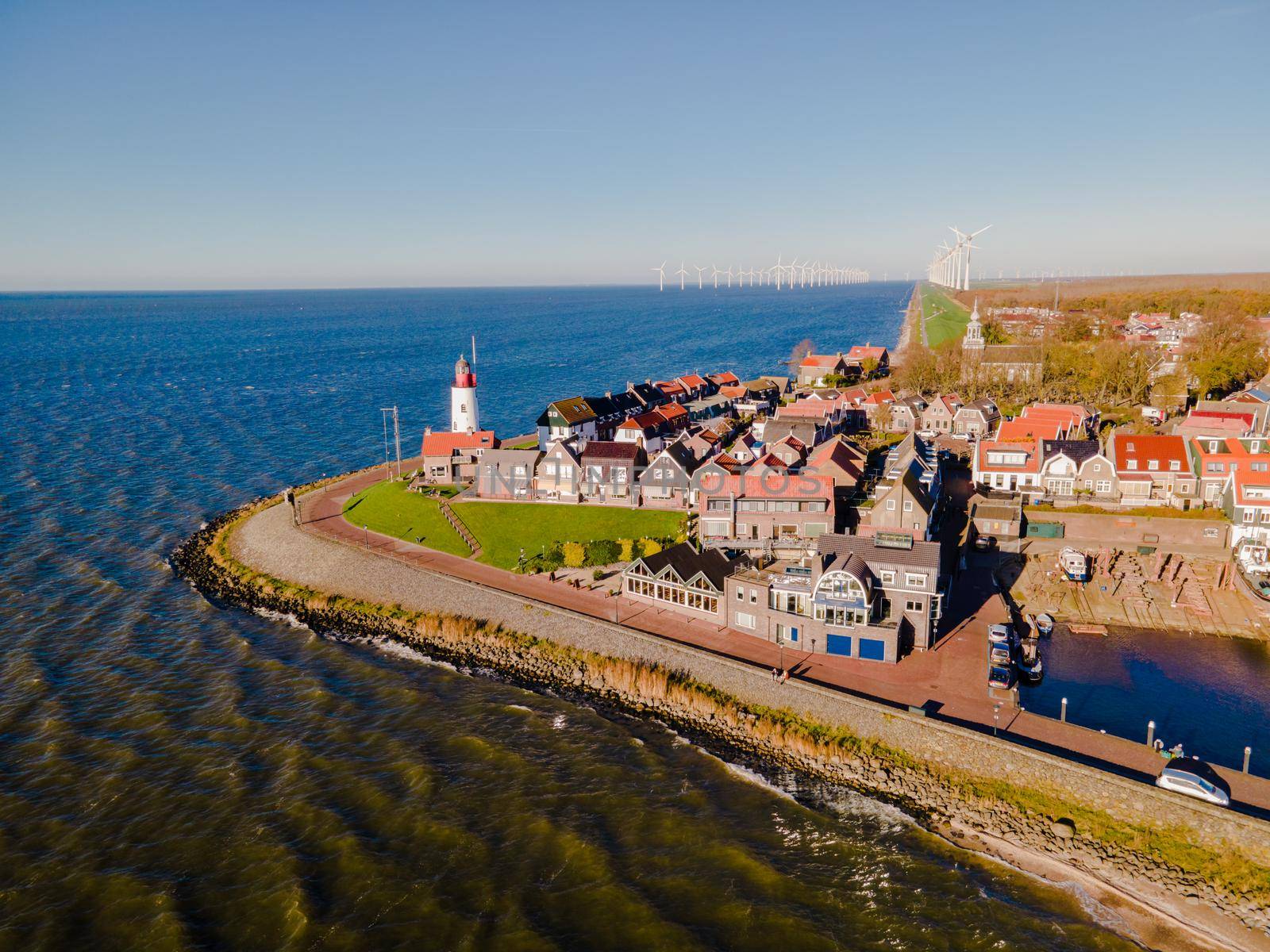 Urk lighthouse with old harbor during sunset, Urk is a small village by the lake Ijsselmeer in the Netherlands Flevoland area by fokkebok