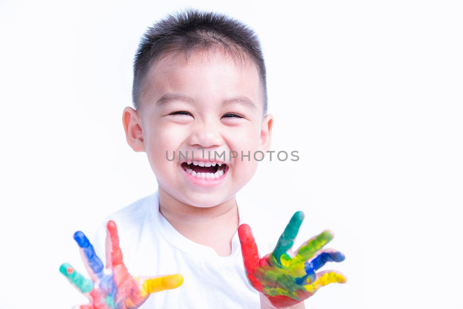 Happy asian child kid smile on education art show hand with water color or finger paint on hands by Sorapop