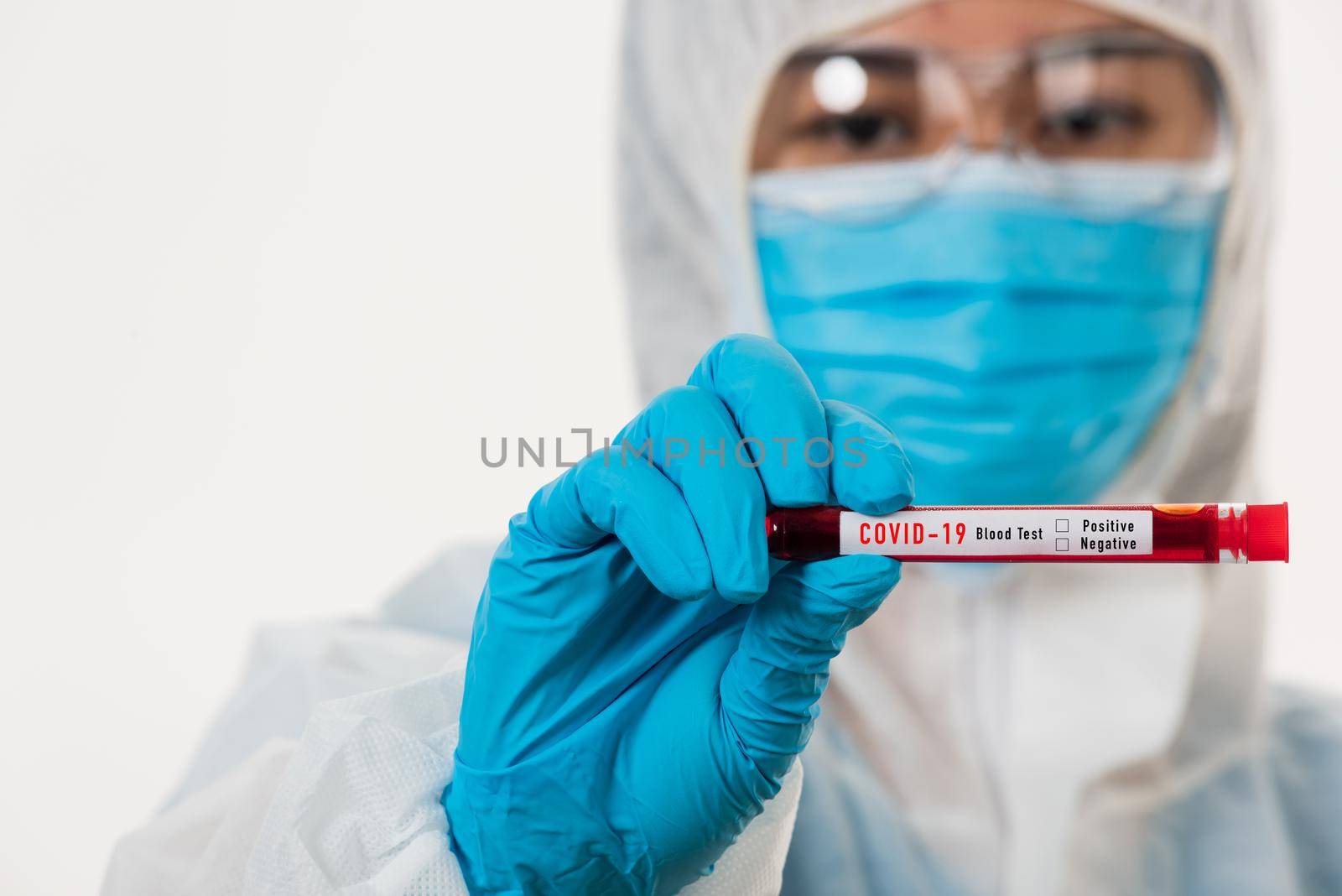 Medical scientist in PPE uniform wear a mask holding test tube Coronavirus test blood sample in a hospital laboratory for analyzing isolated on white, medicine COVID-19 pandemic outbreak concept