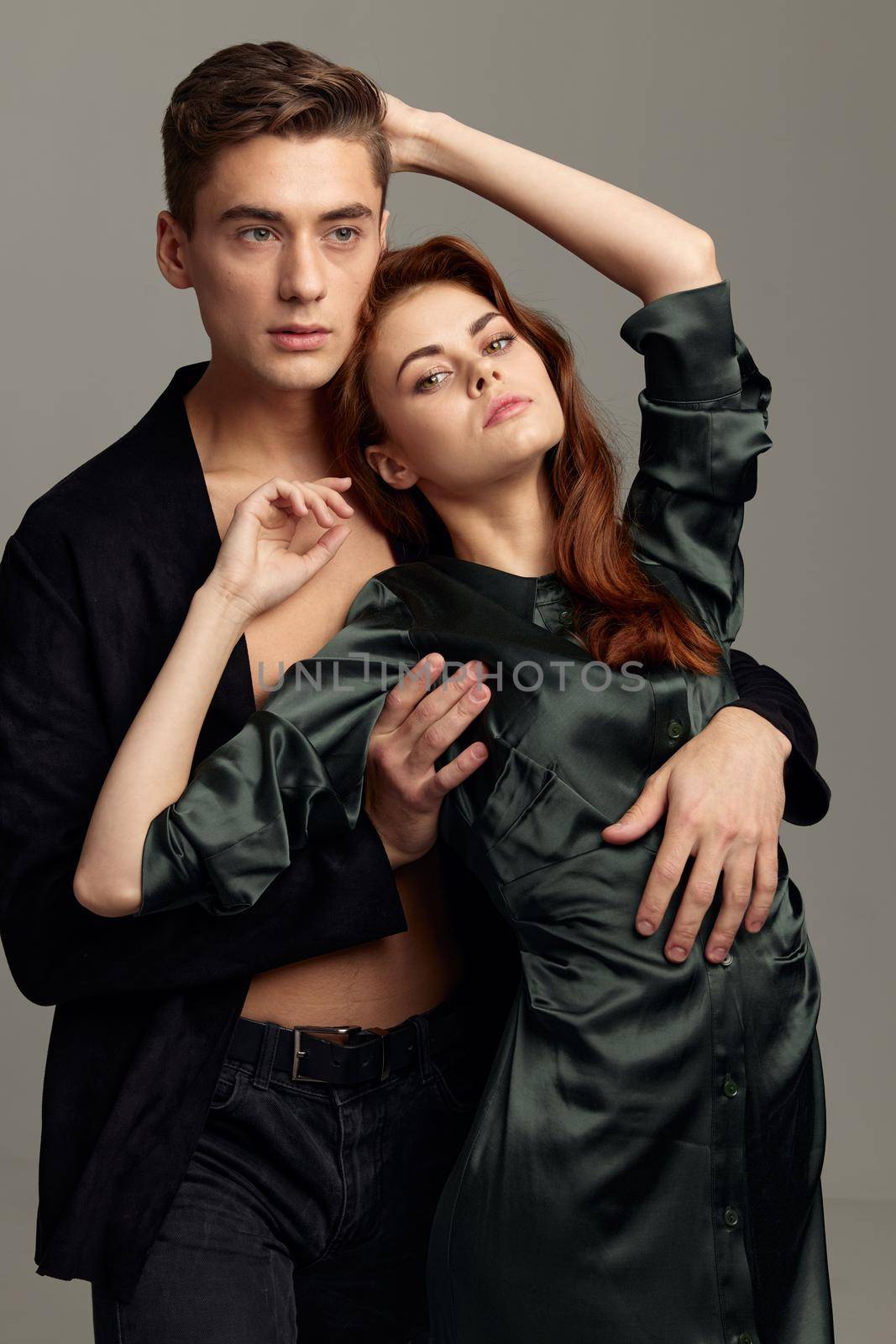 Woman with hands raised up and a sexy man in a shirt. High quality photo