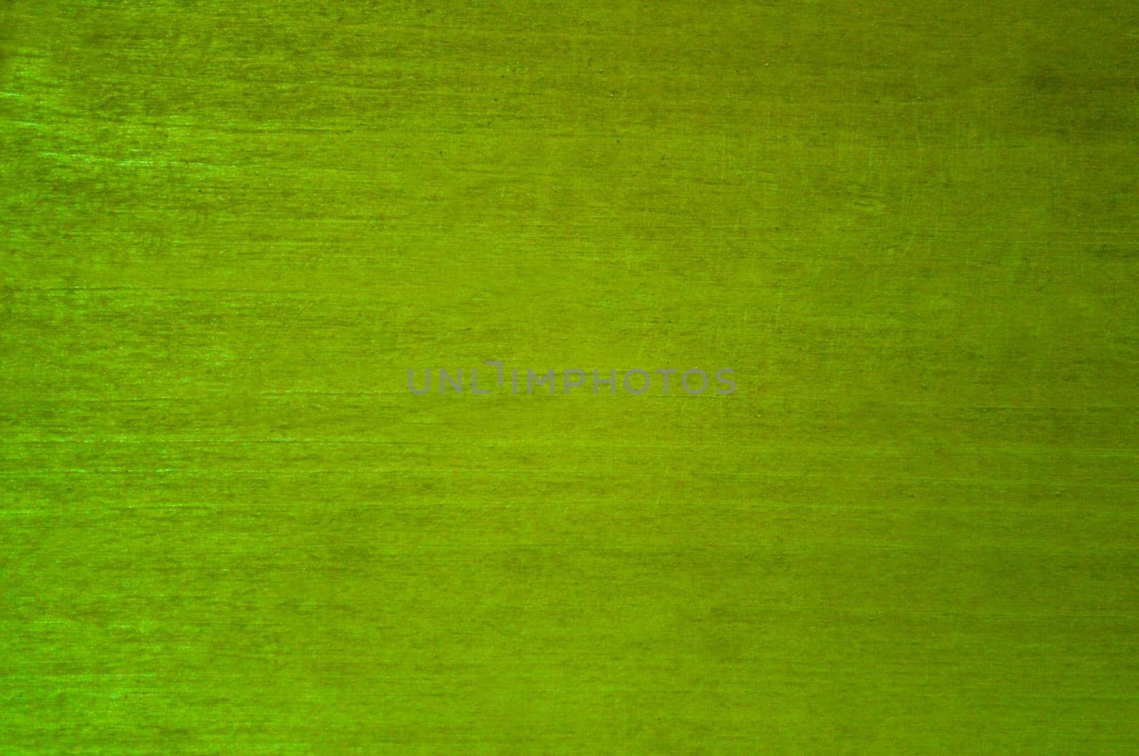 Old plywood sheet painted green. Close-up. Background. Texture.
