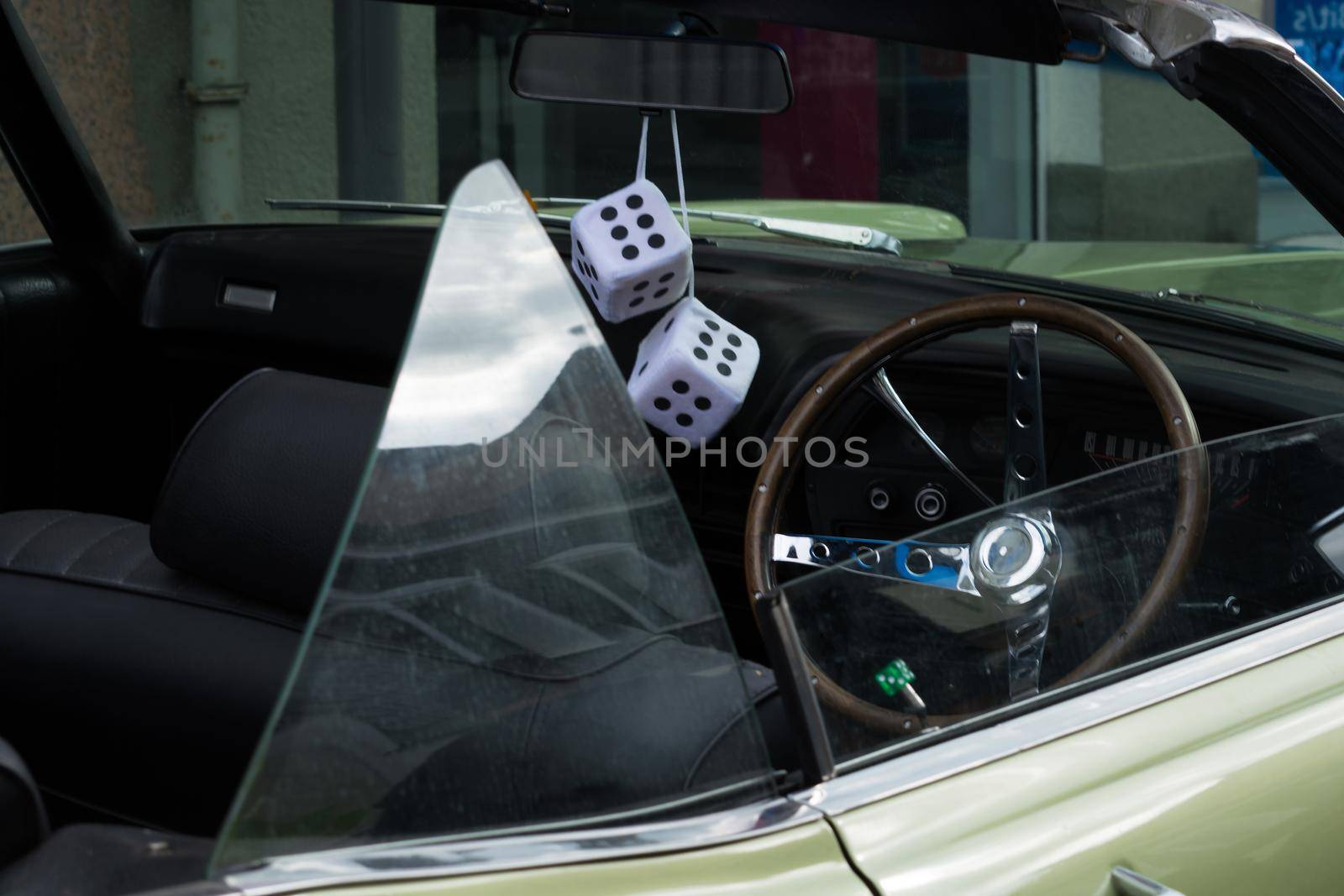 Fuzzy Dice on the rearview mirror of a vintage American car