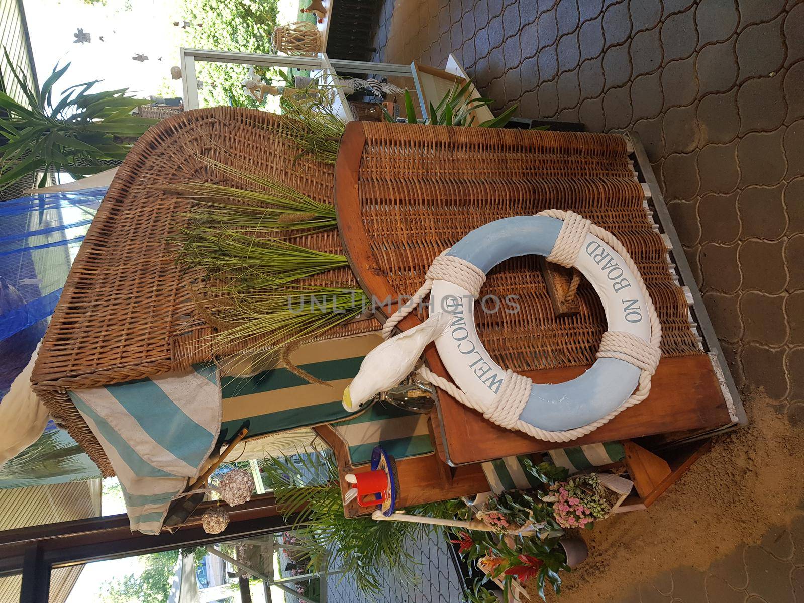 Wicker beach chair with lifebuoy - concept holiday and sea rescue