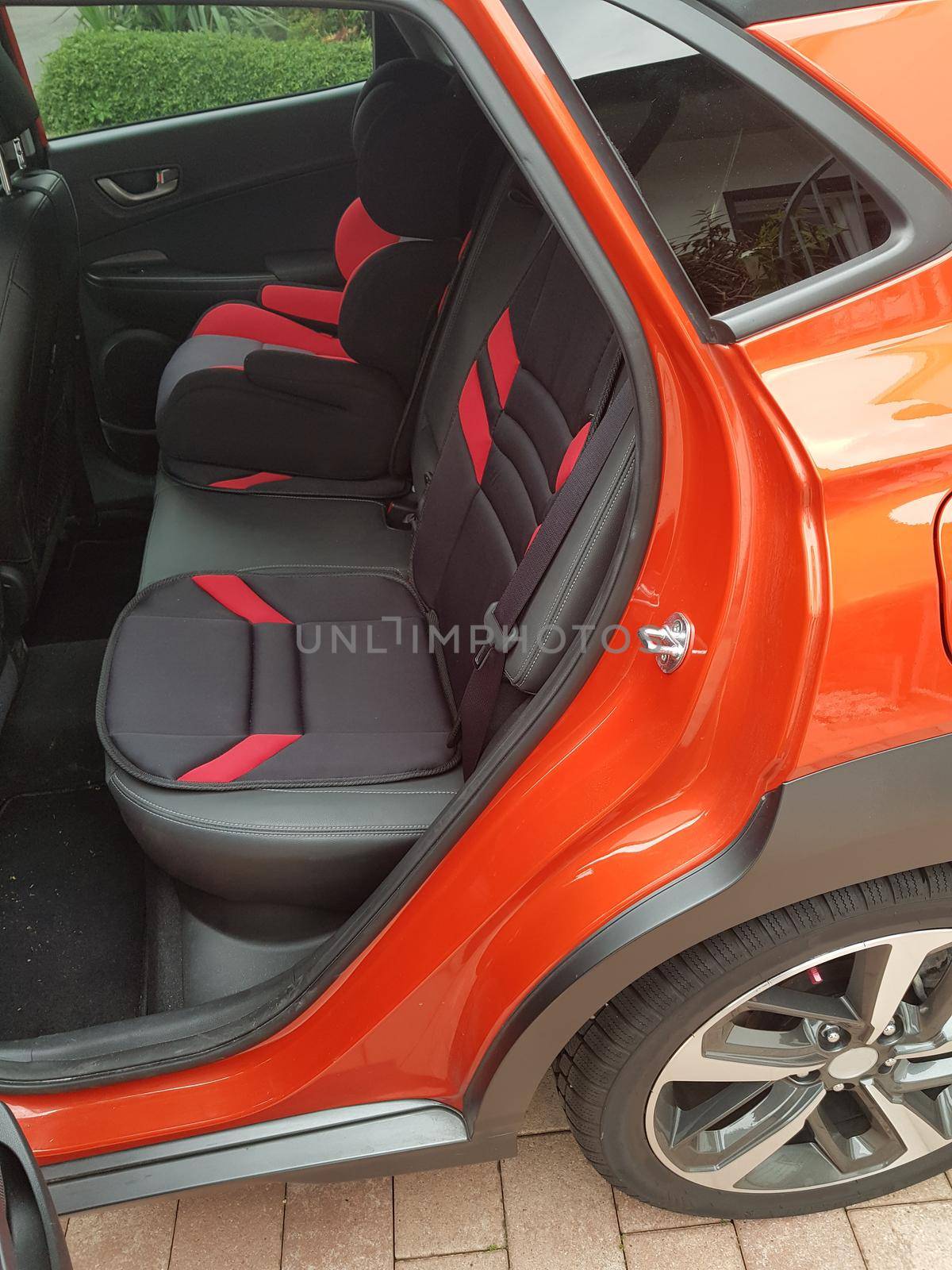 Close up, car interior. Passenger seats in modern luxury SUV car with leather seats and child seat.