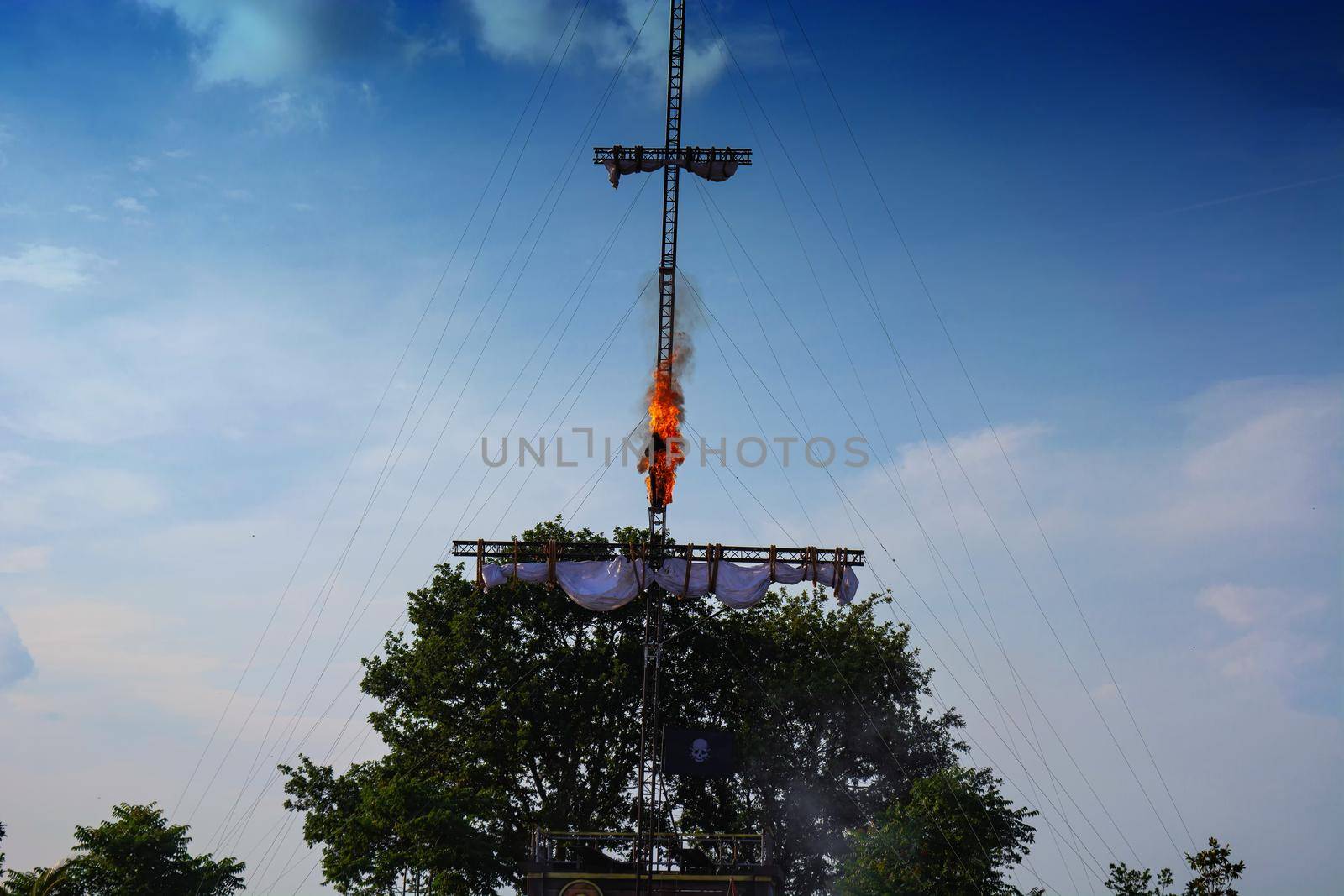 Amusement park show event of a pirate race. A man spring burning from a mast Holland, Europe.