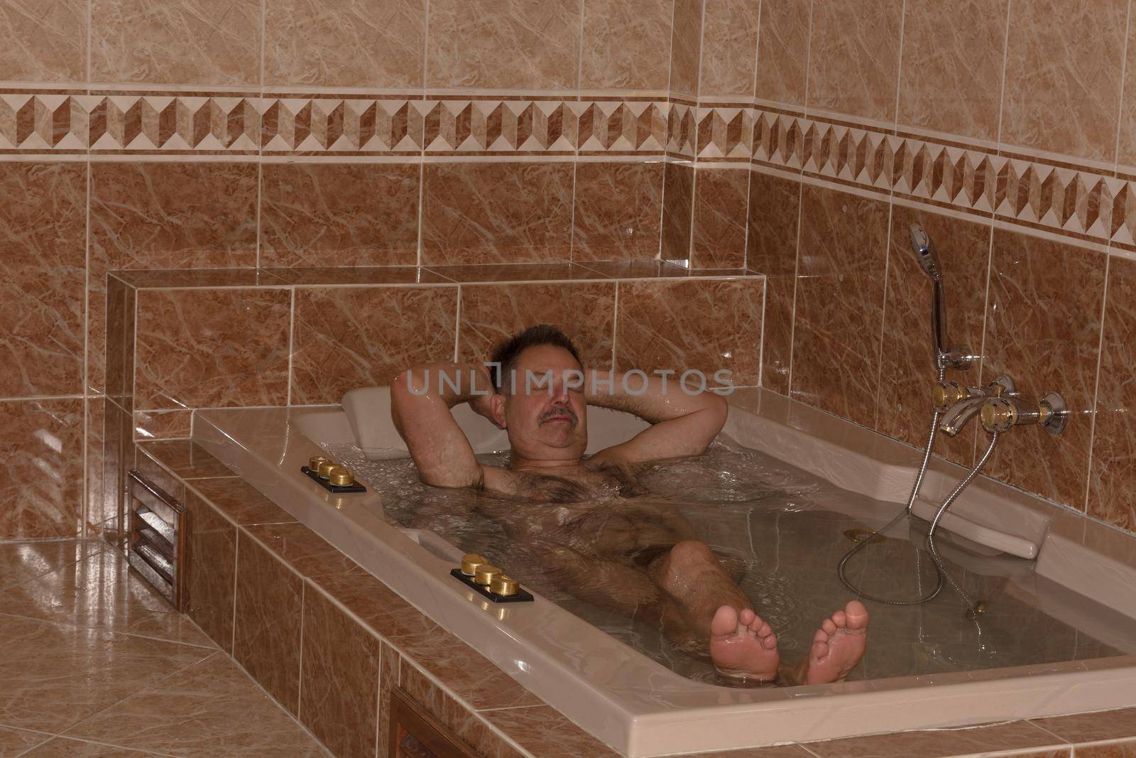 Man in luxury hot tub, shower and sink     by JFsPic