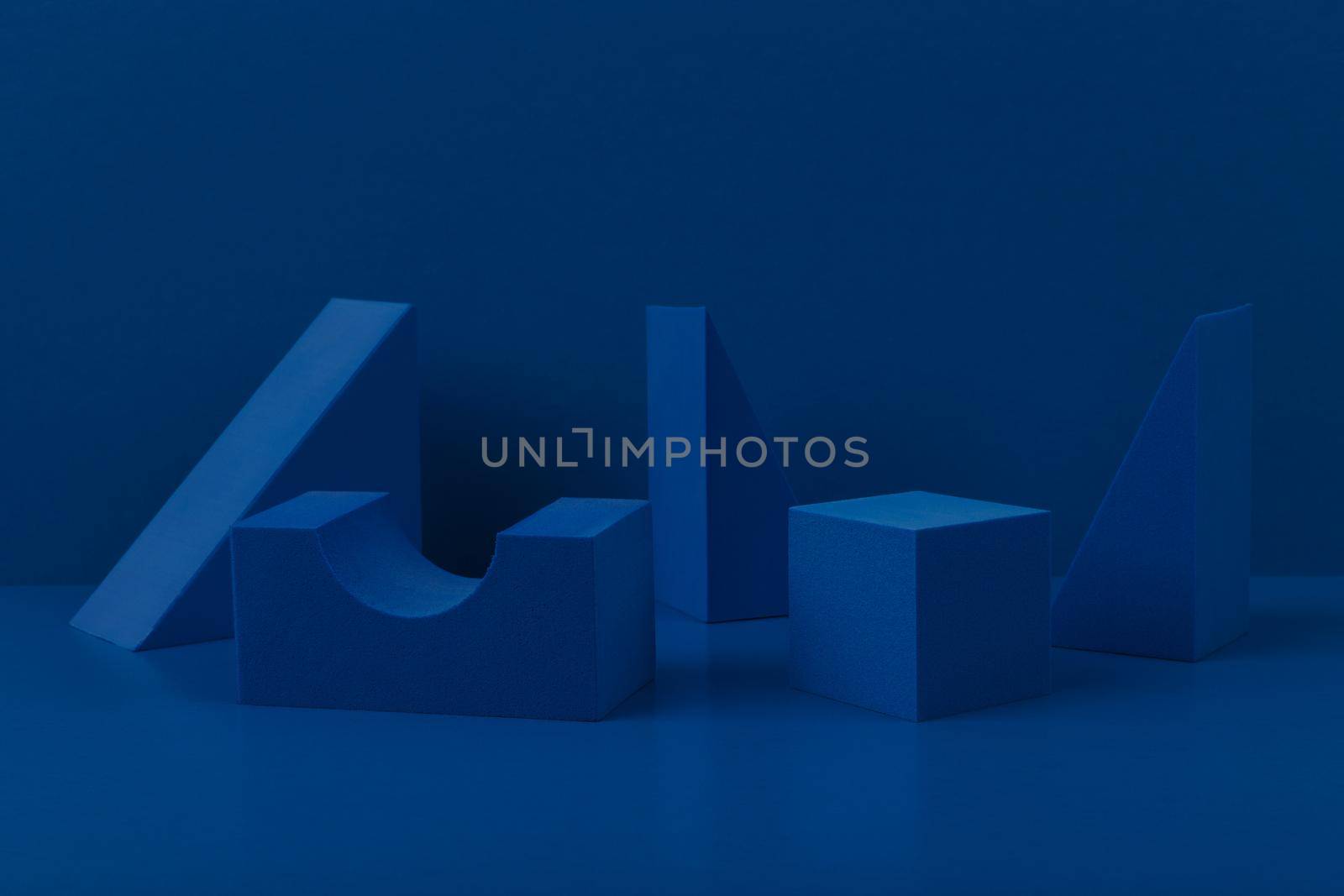 Monochromatic abstract geometric composition with blue geometric figures on blue background. Concept of product presentation or sample for advertising banner