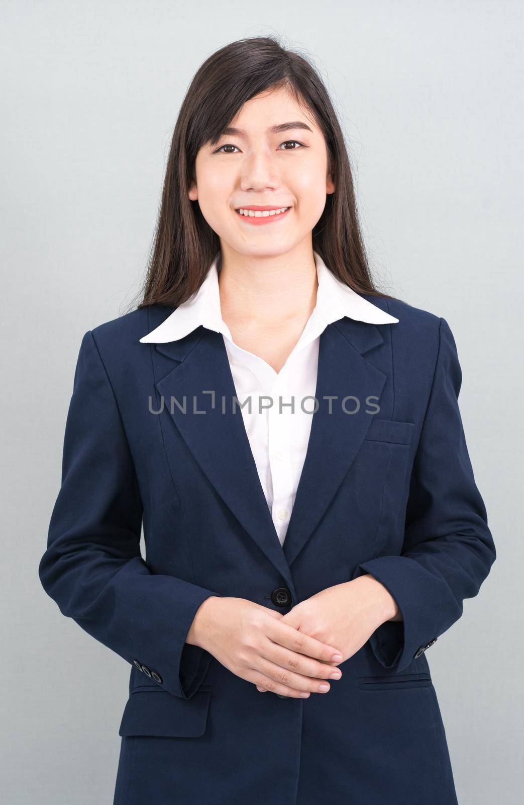 Portrait of asian business woman standing on gray by stoonn