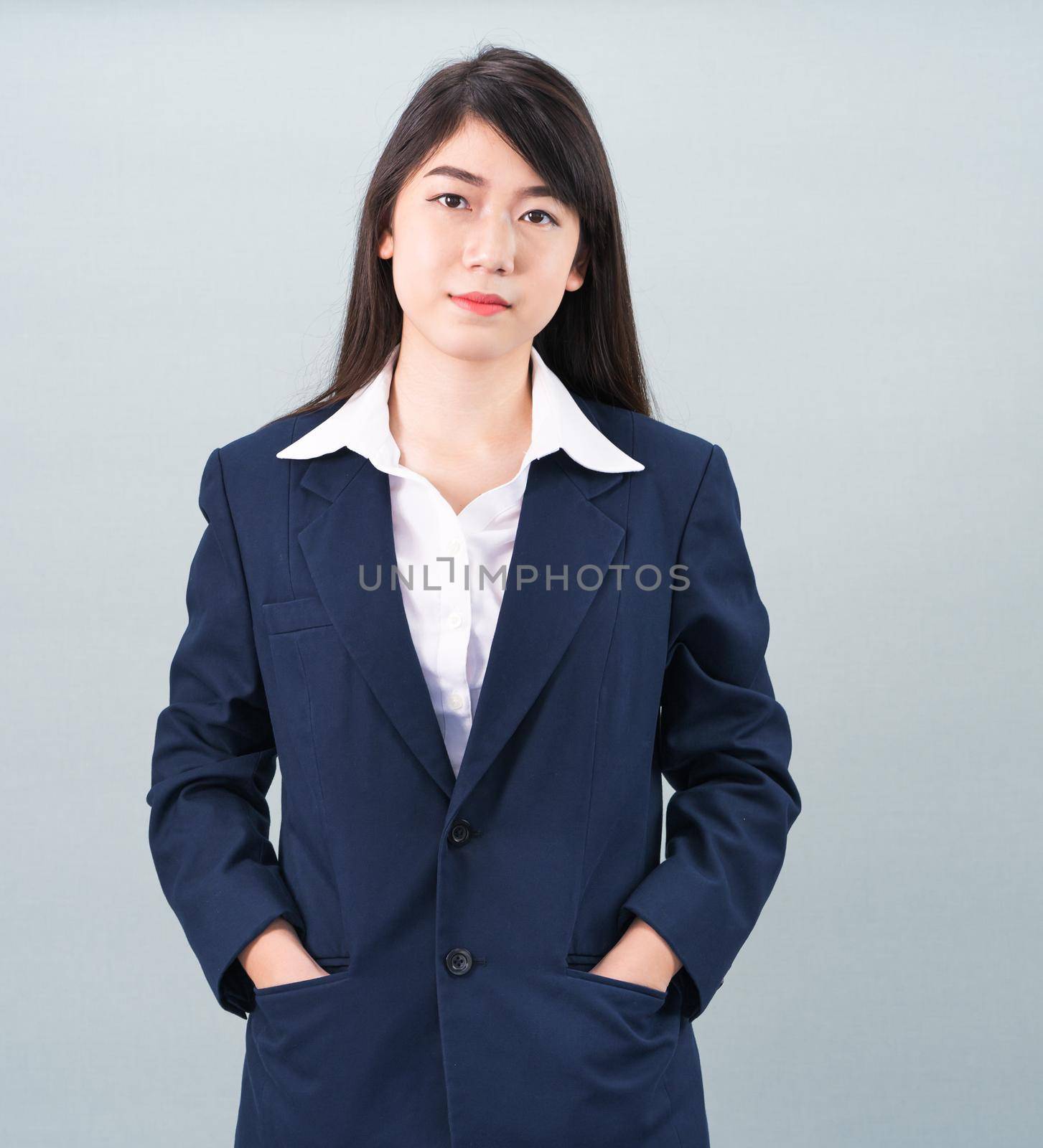 Portrait of asian businesswoman isolated on gray by stoonn