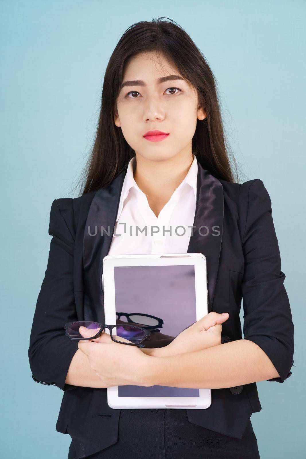 Young women standing in suit holding digital tablet by stoonn