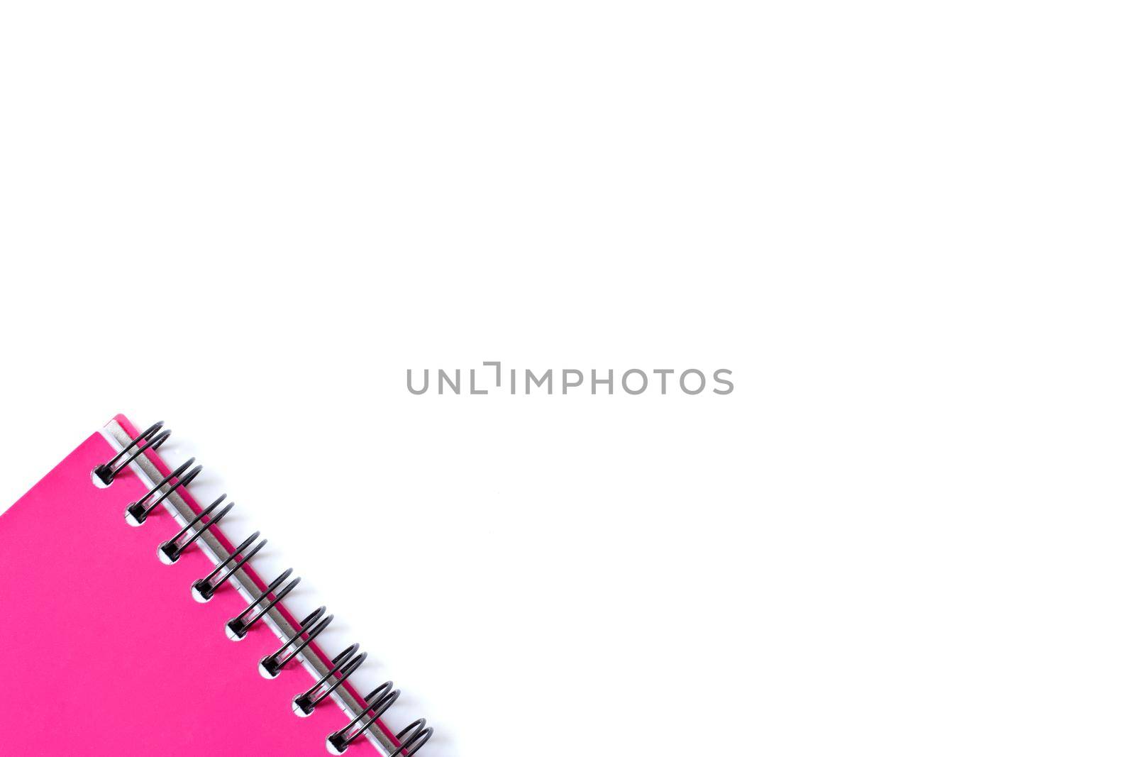 Bright pink spiral planner on white background. Stationery flat lay. Back to school, home office, things to remember concept. White background