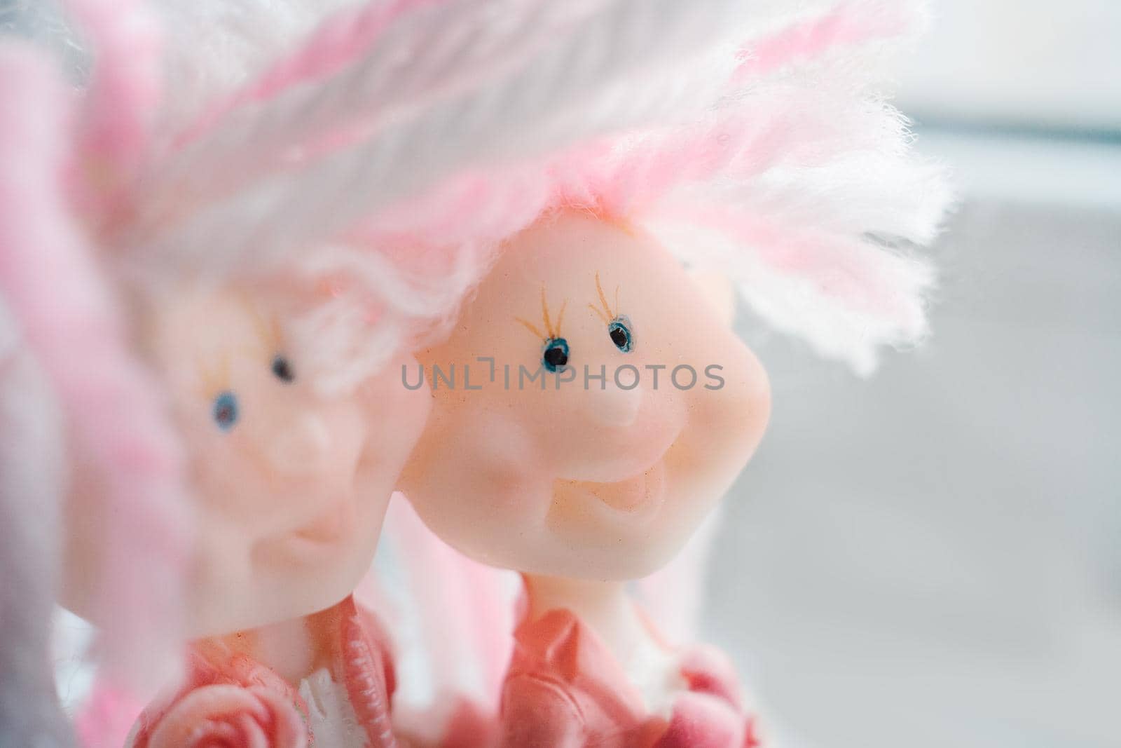 Two funny dolls with funny hairstyles together. The concept of friendship and love. Light photography