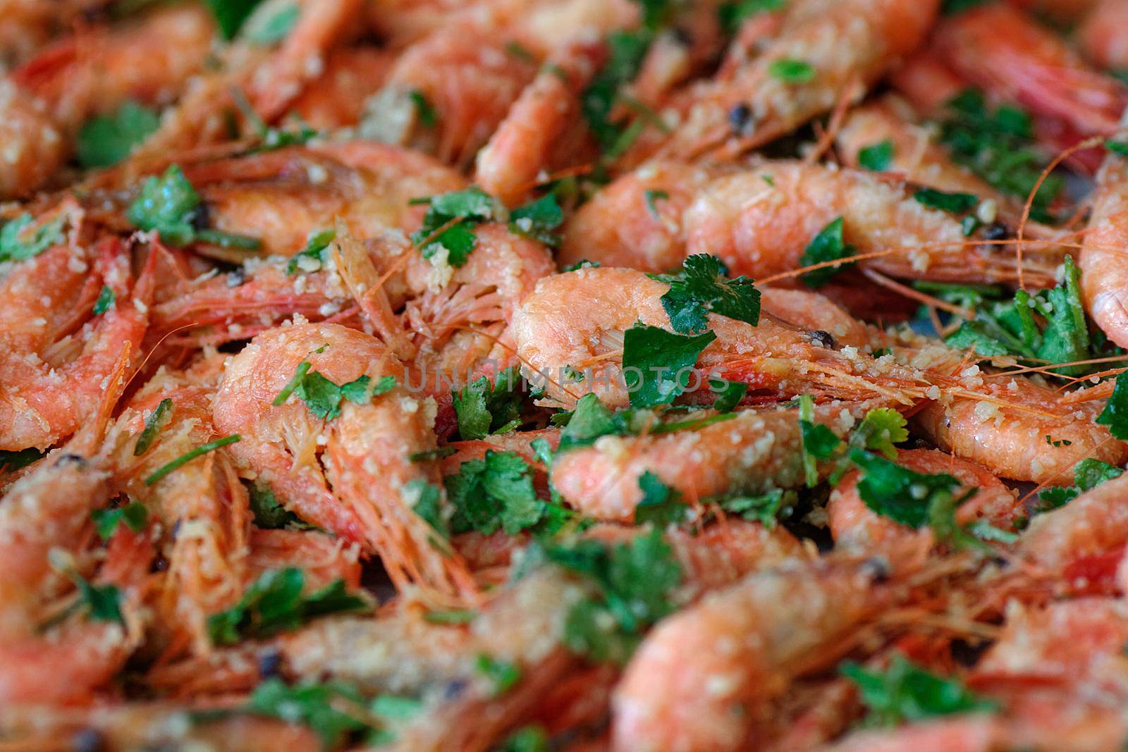 Fresh boiled prawns with coriander. A delicious dish of seafood. Close up. Top view