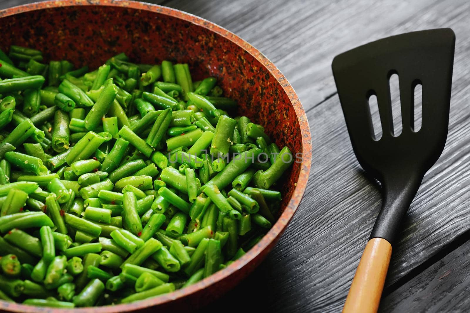 Vegetarian food. Fried string beans in a pan. Stylish background for design. Minimalism. Healthy food from vegetables. by SergeyPakulin