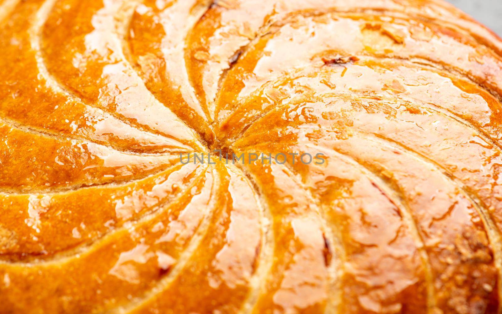 Detail shot of Epiphany cake or galette des rois in French shows the shiny texture of the puff pastry