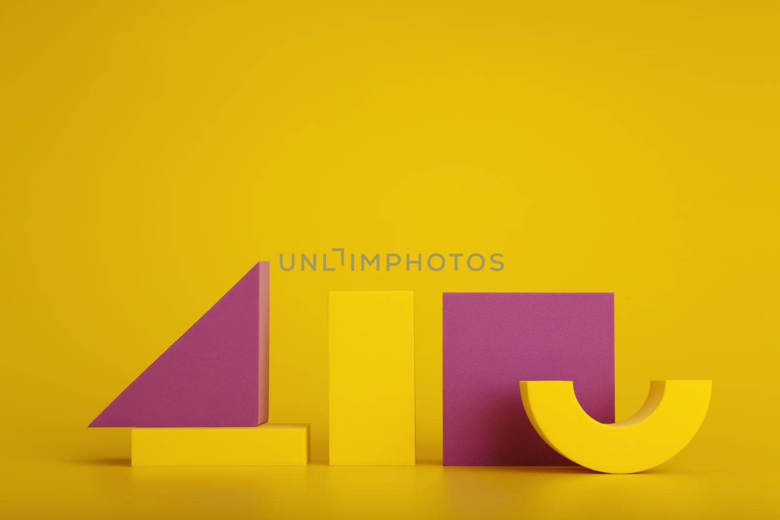 Duotone still life with yellow and purple geometric figures against yellow background with space for text by Senorina_Irina