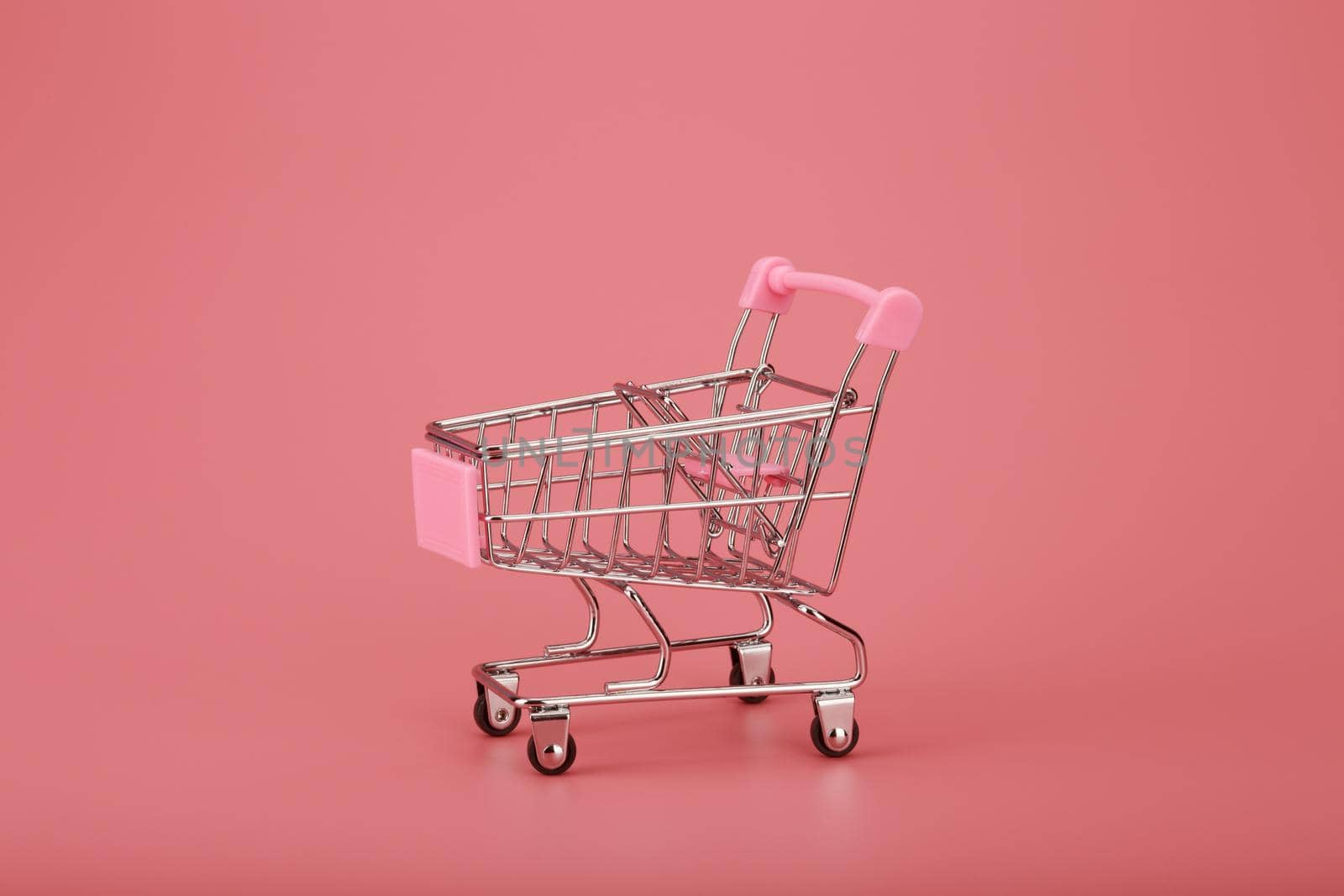 Shopping cart on pink background by Senorina_Irina