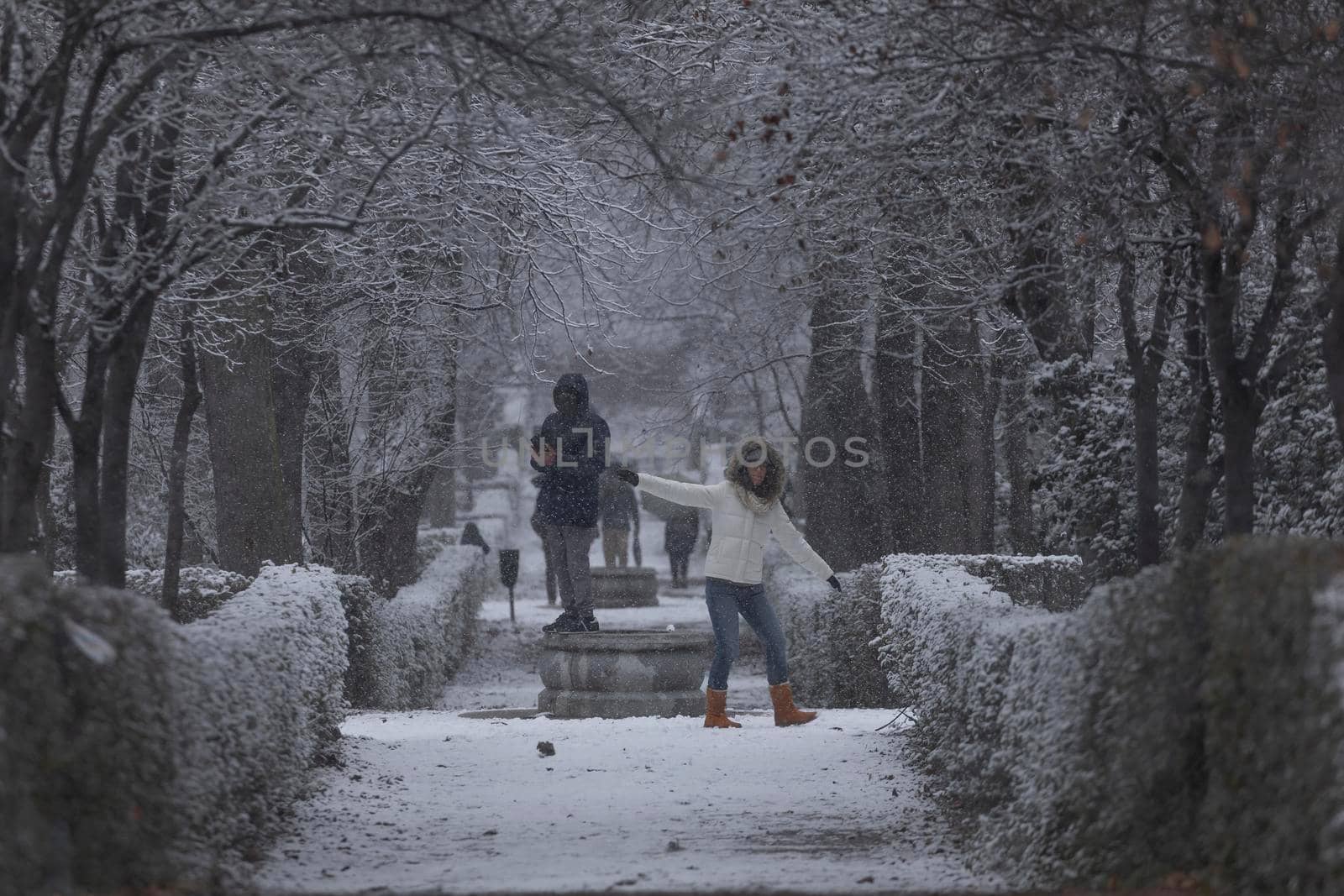 People enjoying a snowy day in the Retiro park, Madrid. by alvarobueno