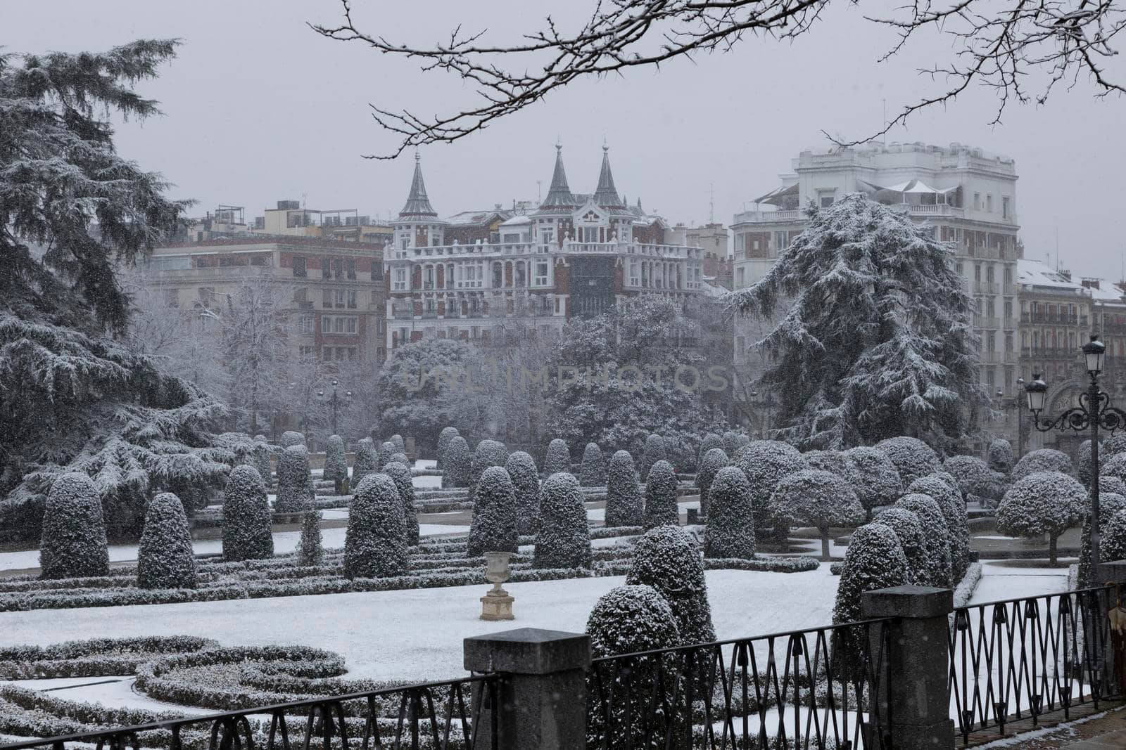 Madrid, Spain - January 07, 2021: General view of the Parterre gardens, in the Buen Retiro park in Madrid, in the middle of a snowy day, due to a wave of polar cold.