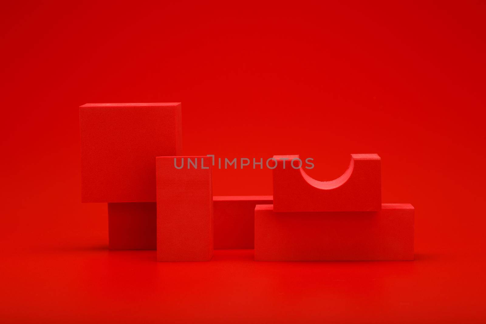 Abstract monochromatic still life in red colors with red geometric figures on red background. Concept of sample for advertising 