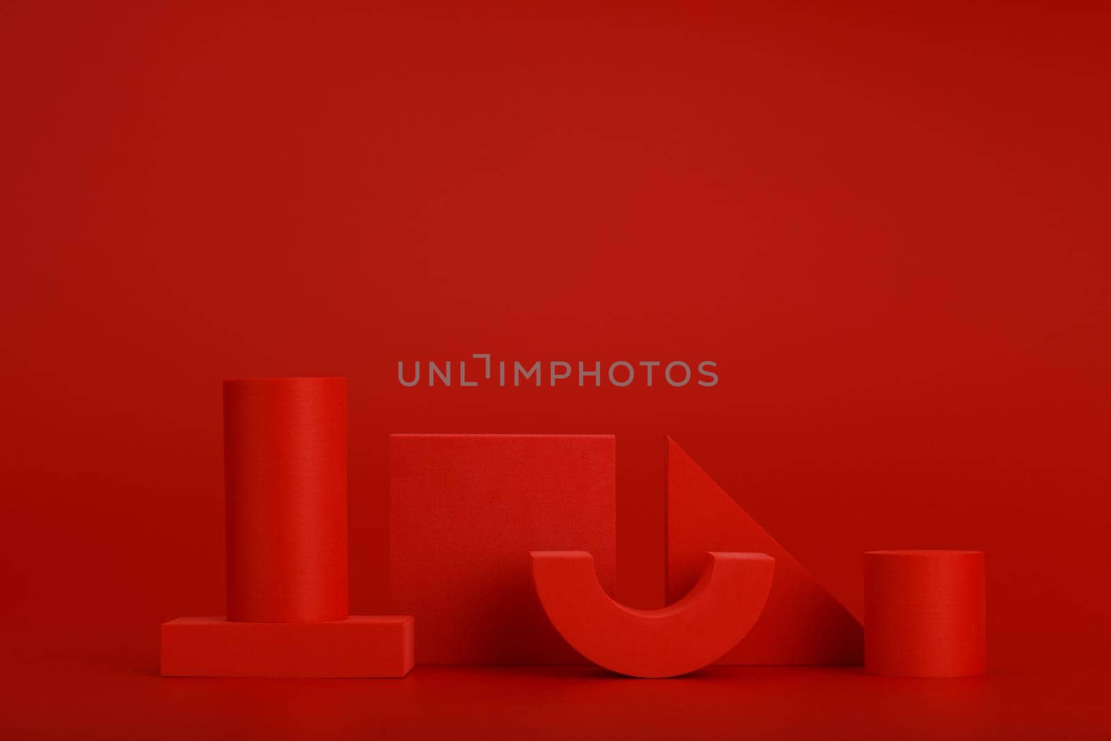 Abstract monochromatic still life in red colors with different geometric figures on red background with space for text by Senorina_Irina