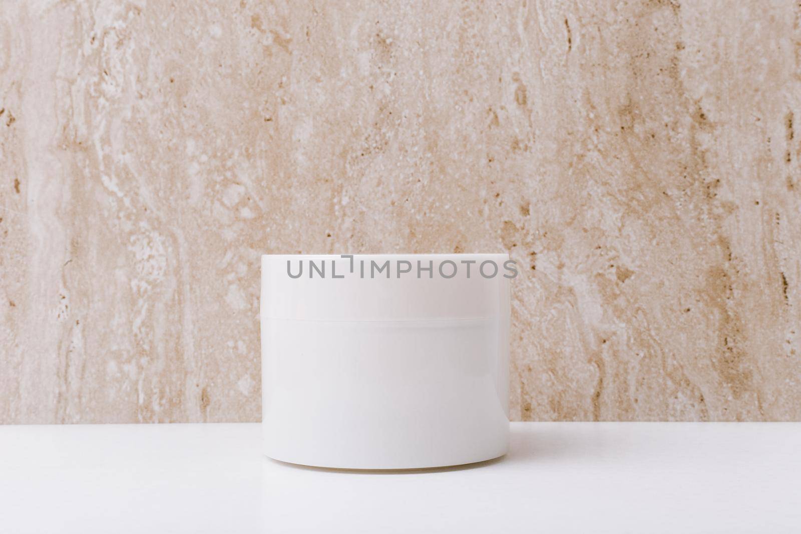 Close up of white unbranded cream jar on marble background with space for text . Concept of beauty and skin care in minimalistic style. 