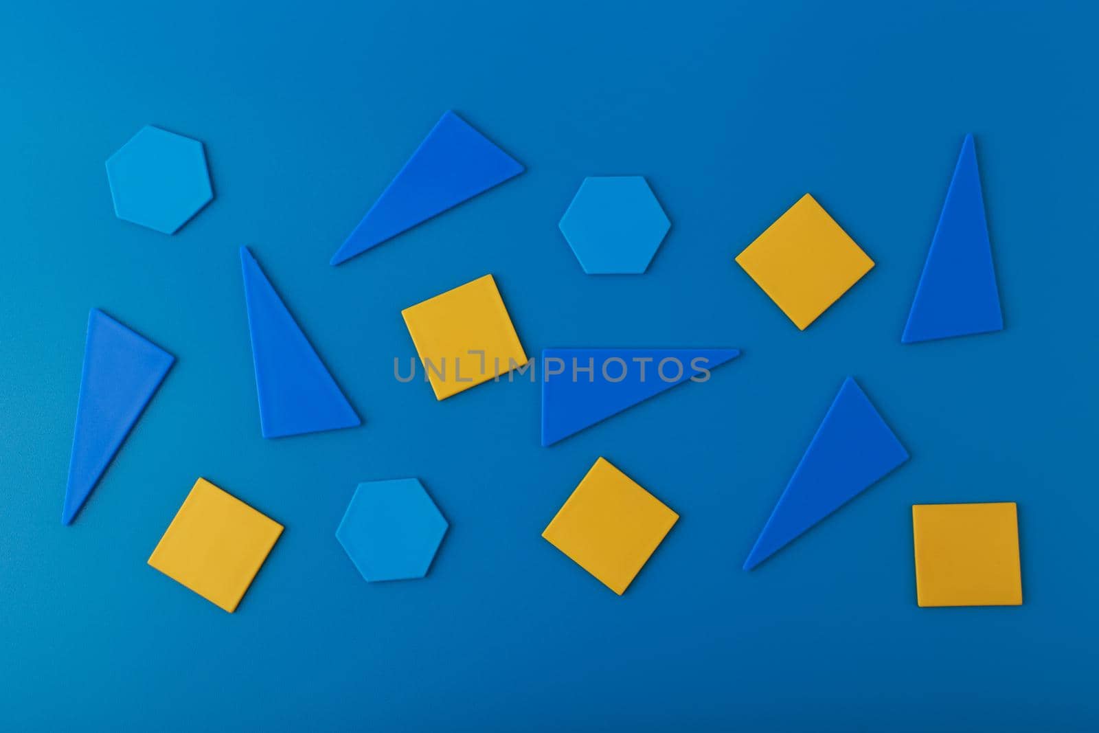 Abstract futuristic background with blue triangles, hexagons and orange squares on blue background
