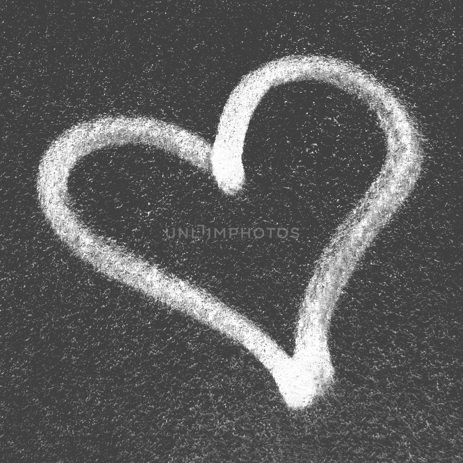 Black heart on grungy wall. Concept or conceptual painted black abstract heart shape love symbol, dirty wall background, metaphor to urban and romantic valentine, grungy style.