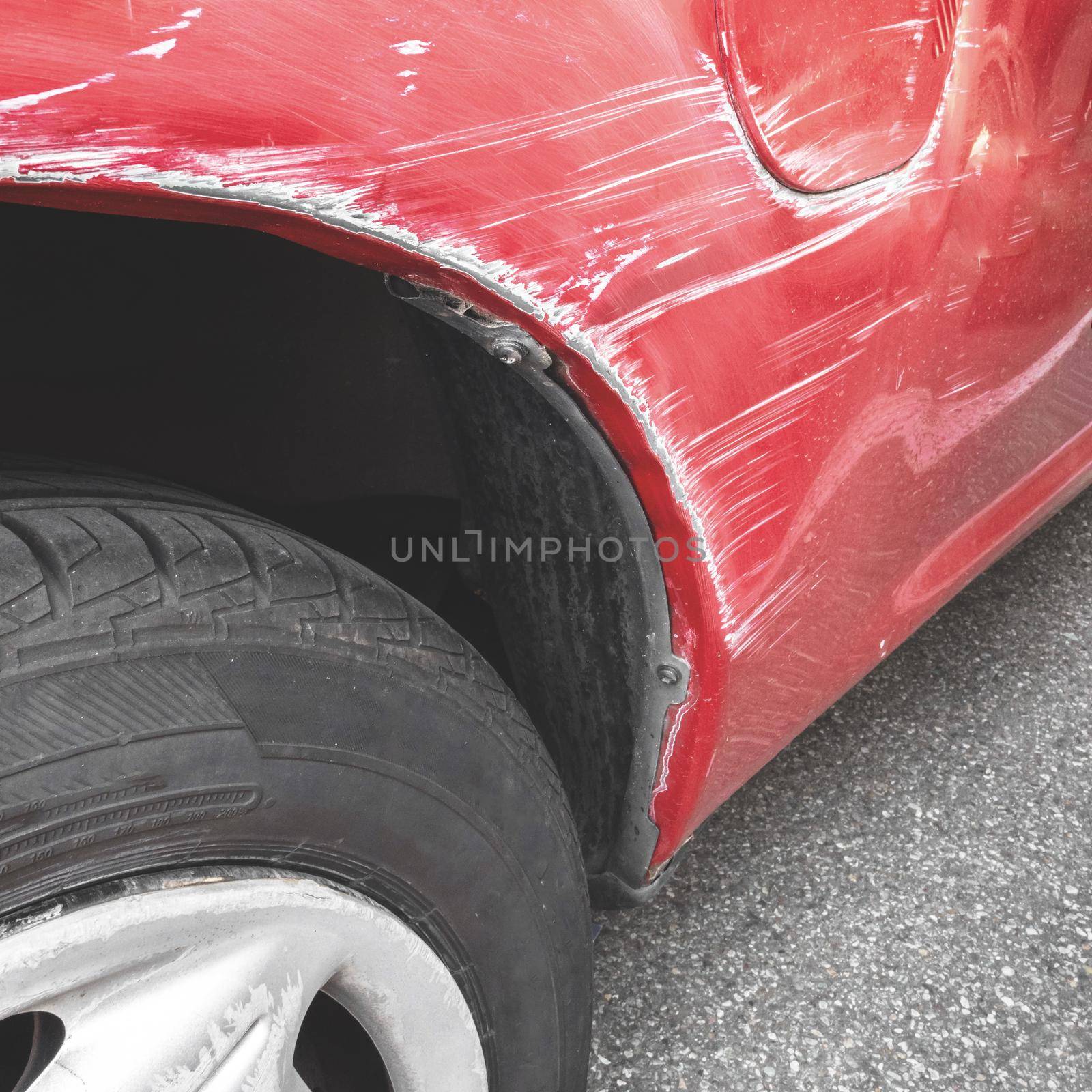 Car paint scratch close-up. Generic car with scratched paint and dented body in crash accident or parking lot.