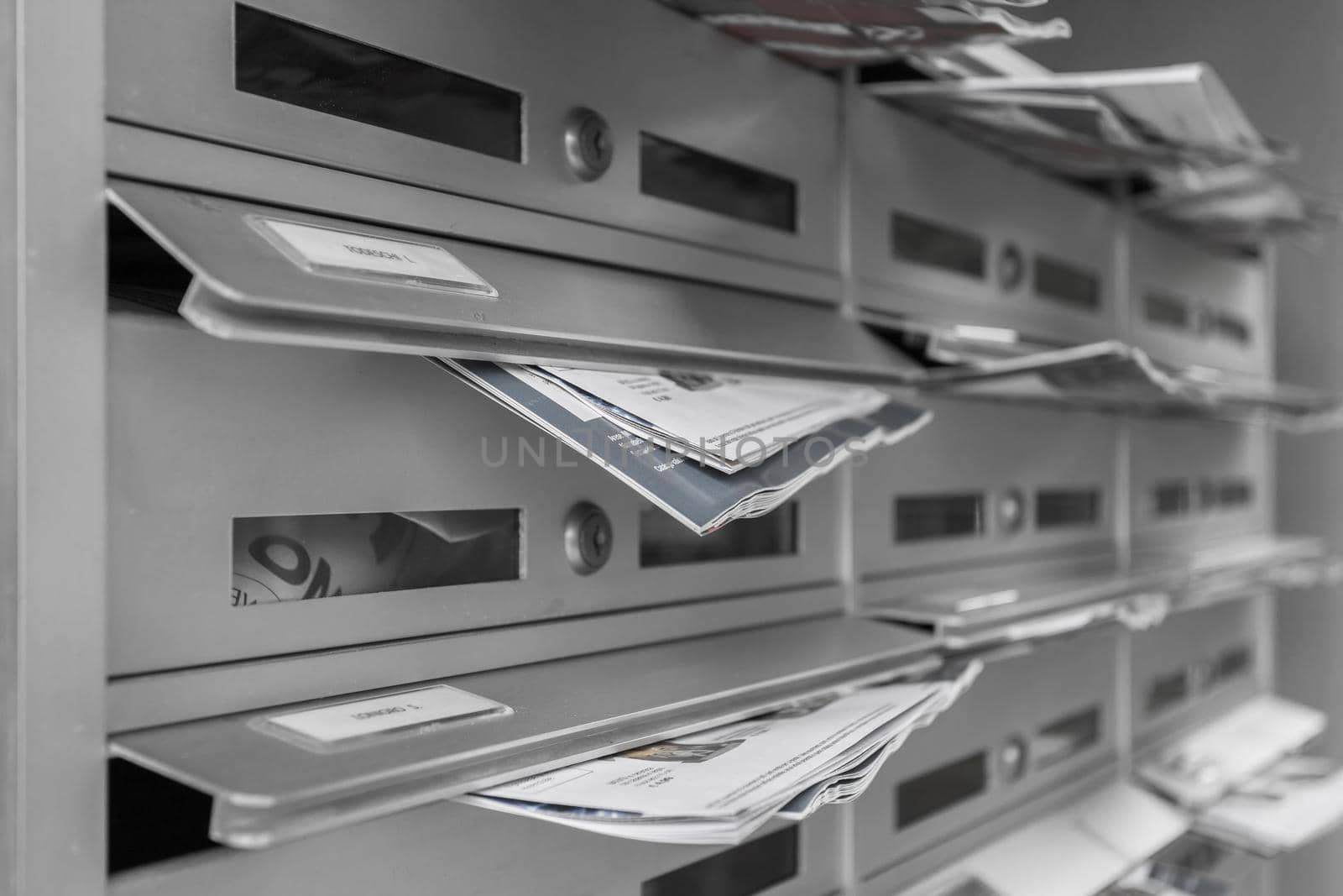 Modern mailboxes filled of flyers. Business and advertising concepts. Shallow depth of field.