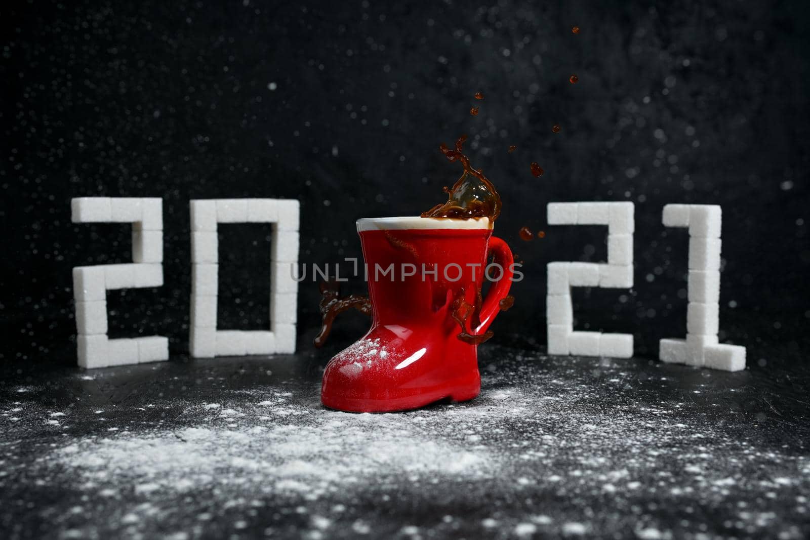 New Year 2021. Coffee splashes and snow in the coming 2021. Figures from sugar.
