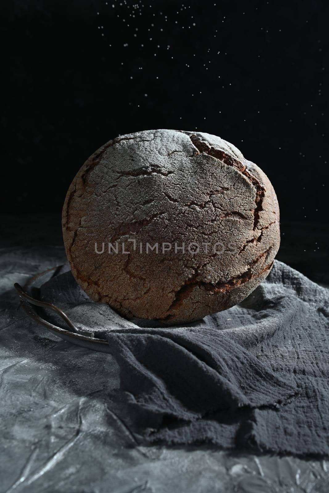 dark space and fresh black bread on gray table. levitation