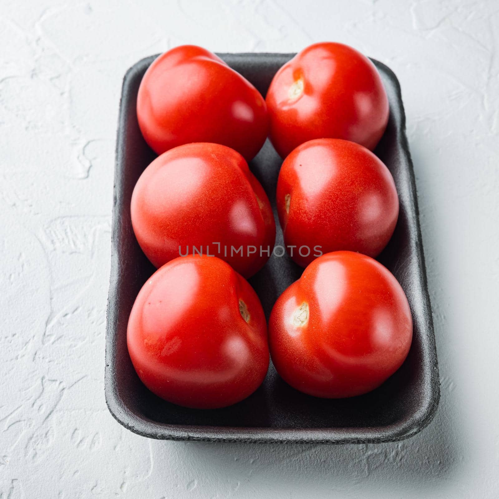 Red ripe tomatoes, on white background