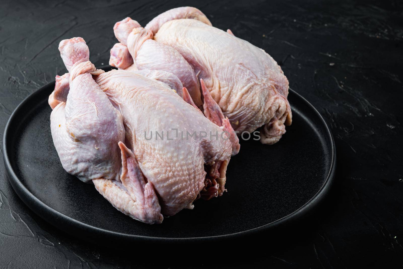 Fresh raw chicken meat, on black background