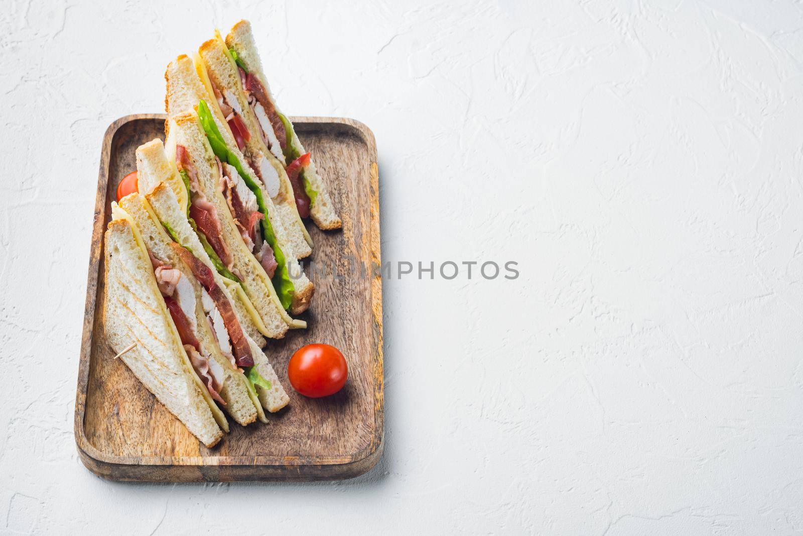 Classic club sandwich with meat, on white background with copy space for text