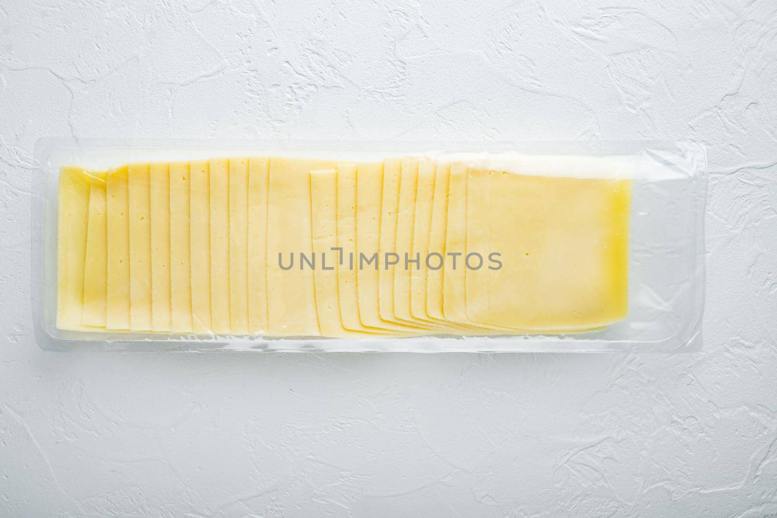 Slices of american cheese plastic pack, on white background
