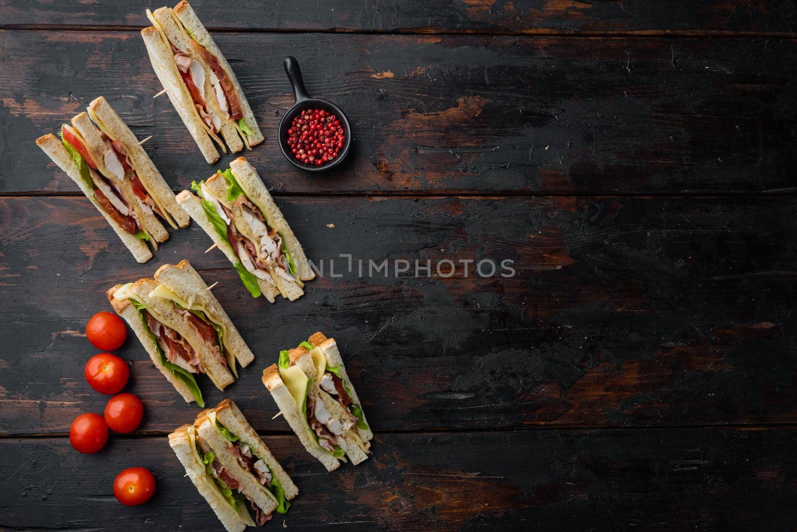 Classic club sandwich with meat, on old wooden table, top view with copy space for text