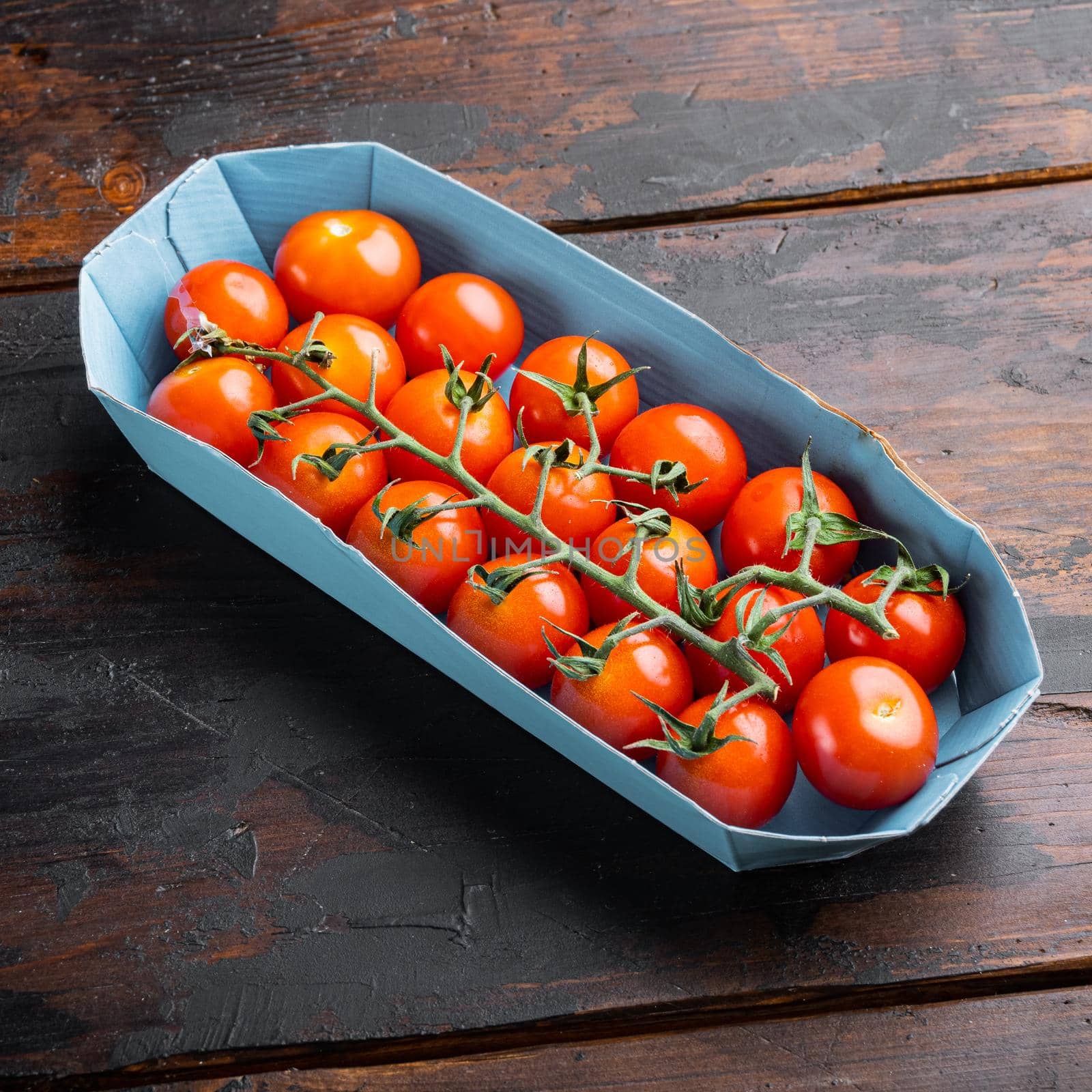 Red small cherry tomatoe, on dark wooden background by Ilianesolenyi