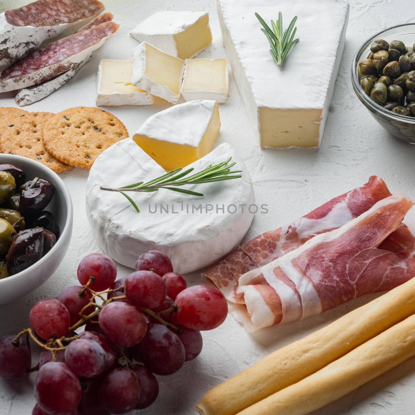 Appetizers table with differents antipasti set, on white background