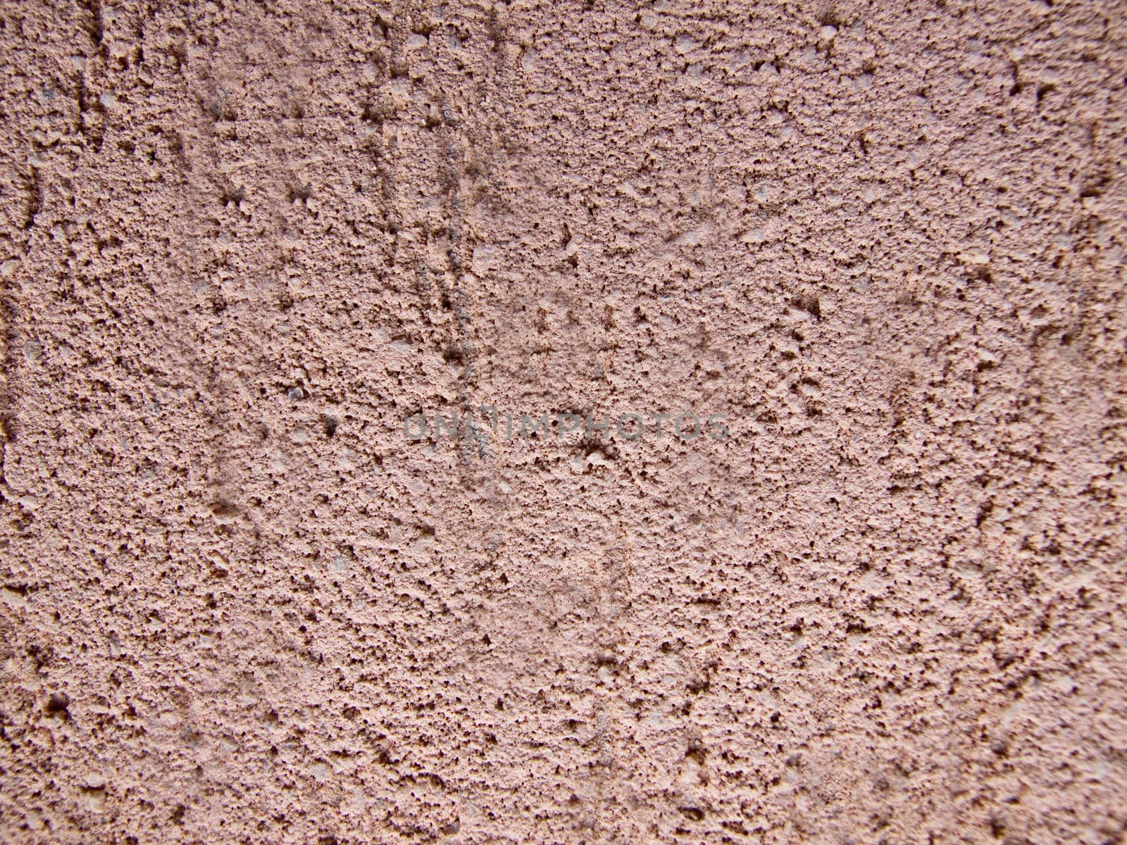 The facade of the house is plastered with decorative brown plaster.Texture or background