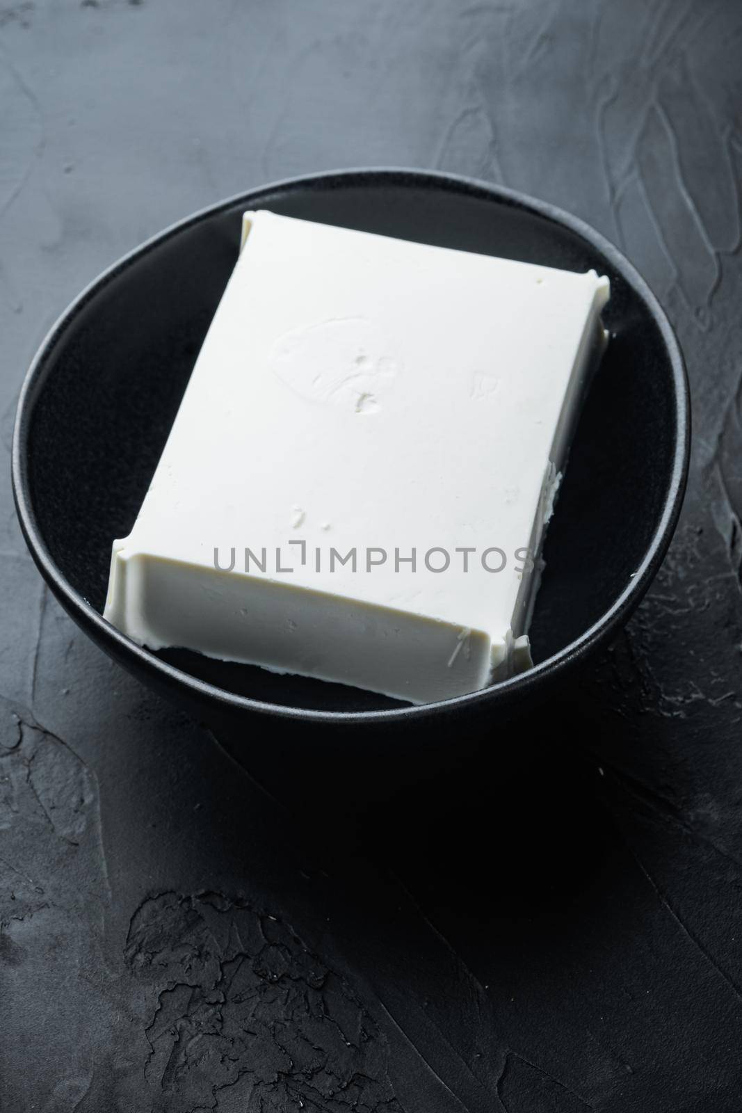 Raw organic white feta cheese set, on black background