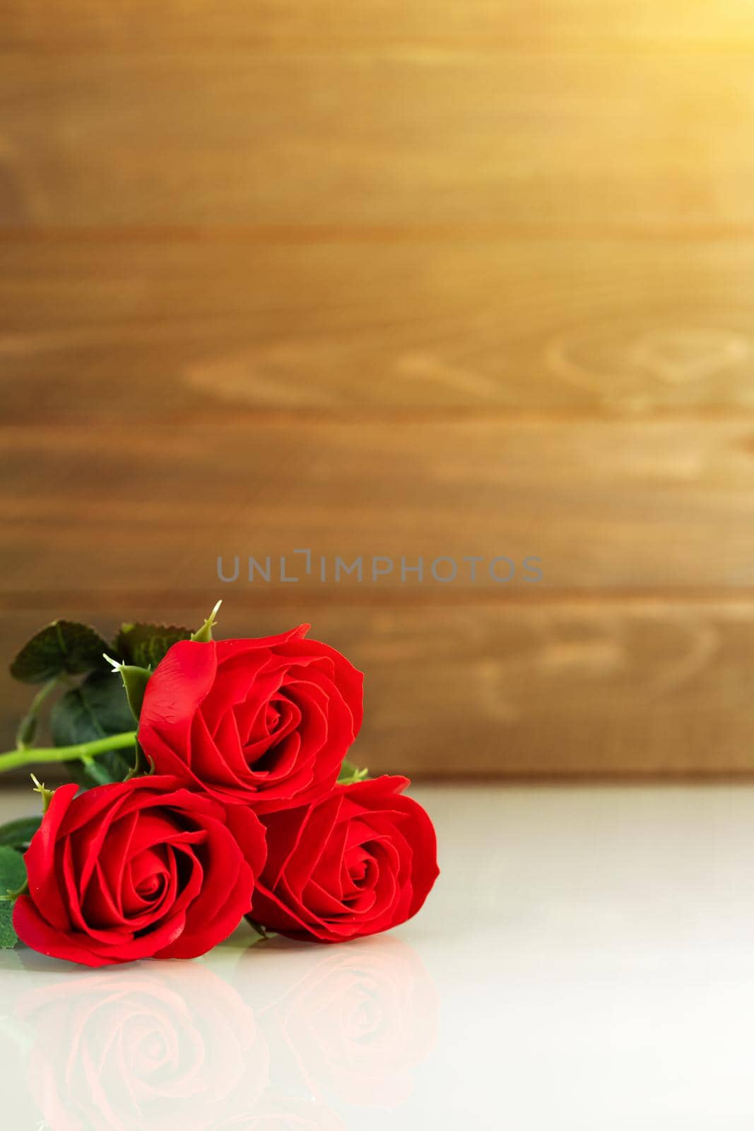 Red roses on table with copy space by stoonn