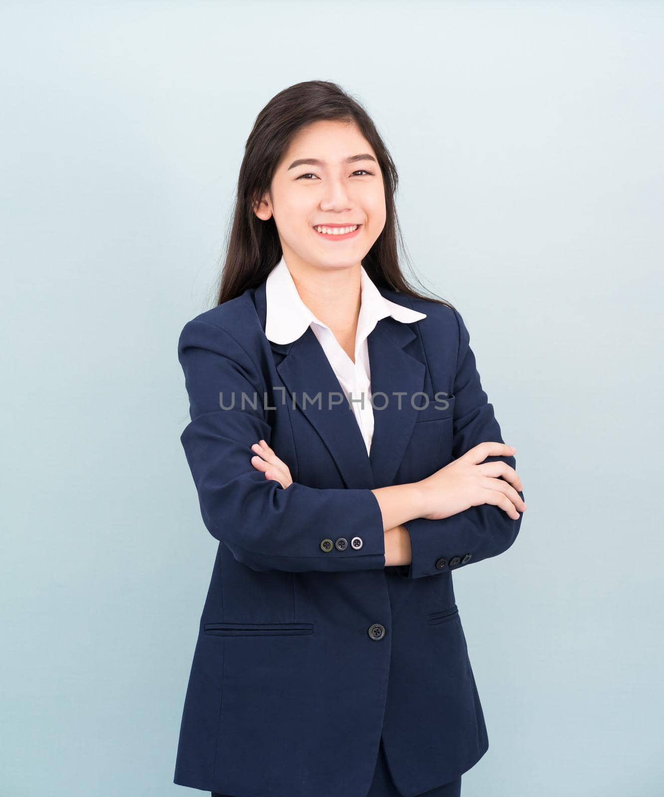 Teenage girl long hair is standing with her arms crossed by stoonn