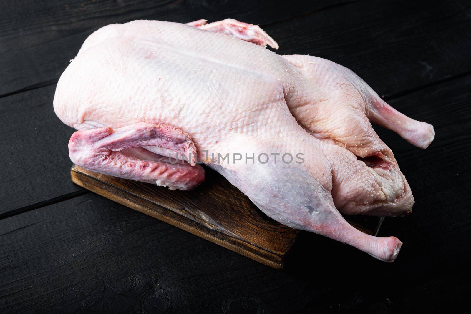 Recipe for cooking whole duck on black wooden table.