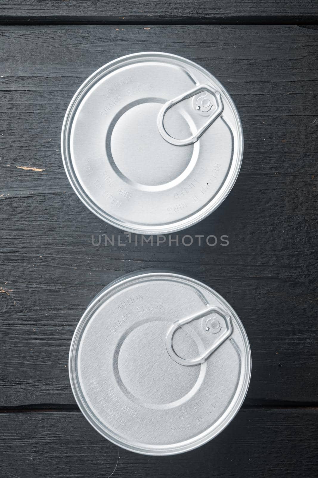 Canned dip tin can, on black wooden background, top view or flat lay