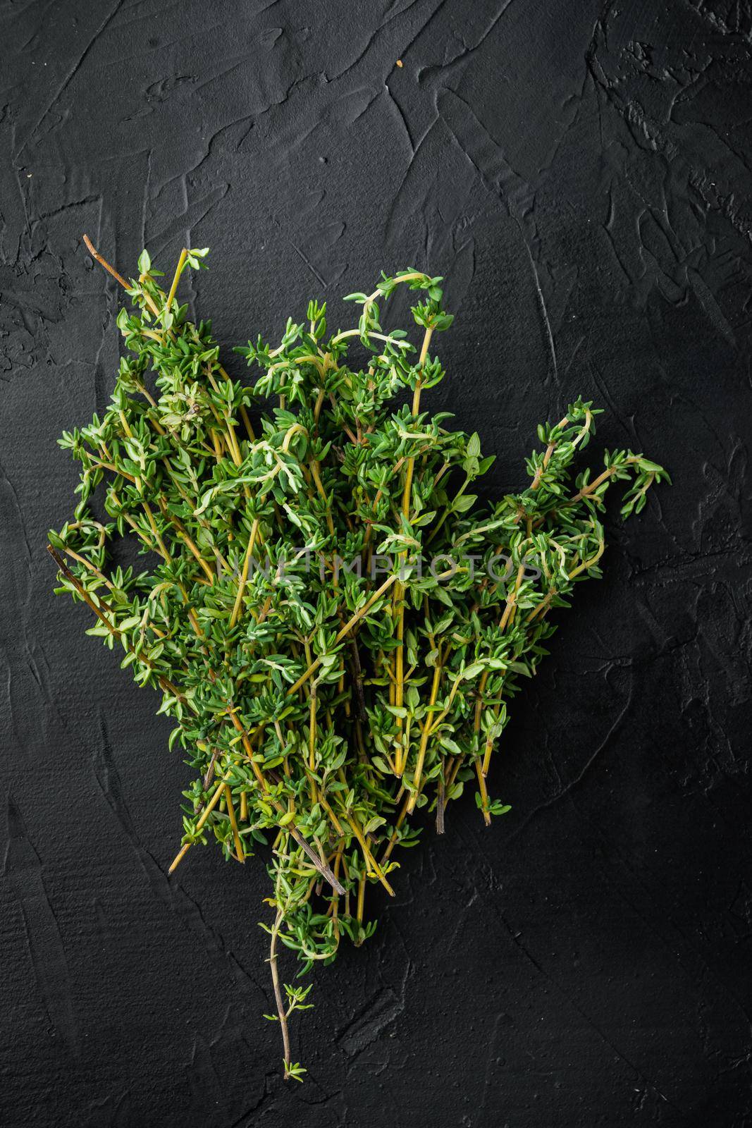 Thyme green fresh bunch, on black background, top view