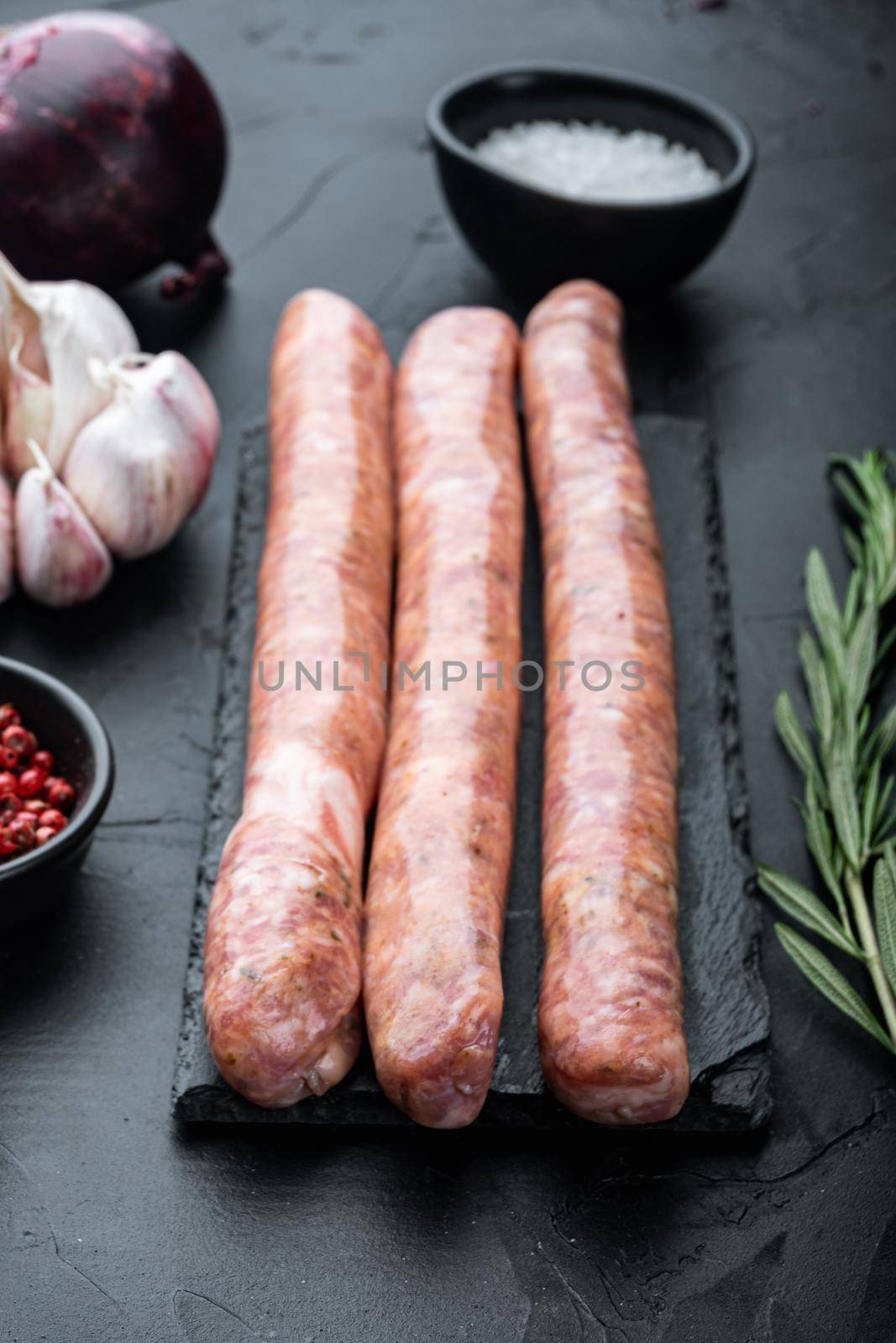 Beef sausages, on black background.