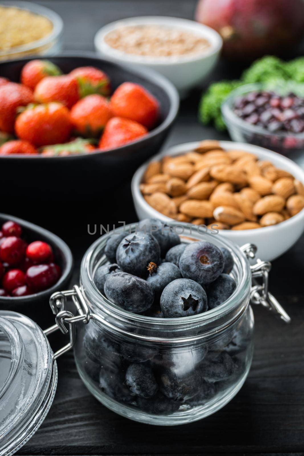 Superfoods dieting clean concept, on black wooden background.
